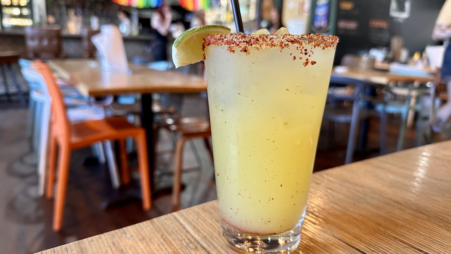 A photo of a margarita with a tajin rim