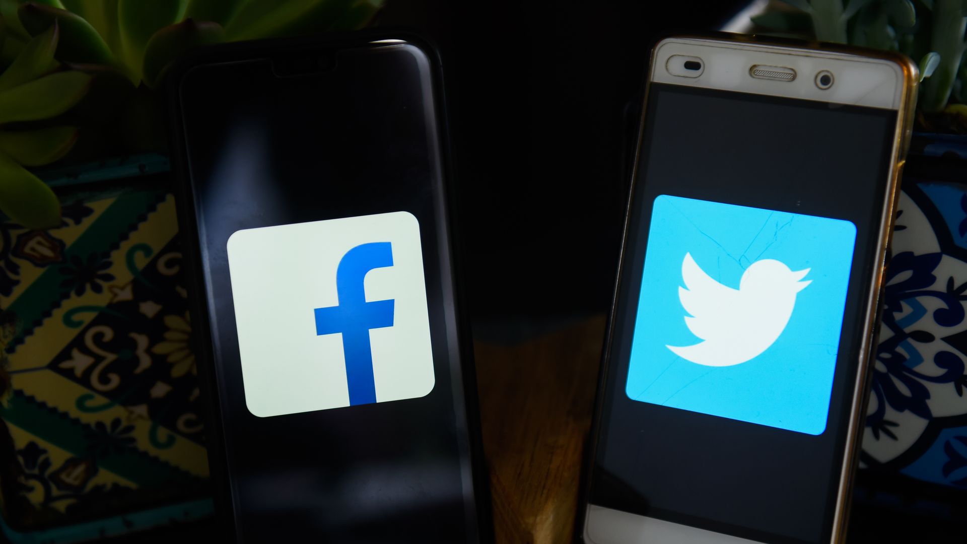 IPhones showing Facebook and Twitter logos