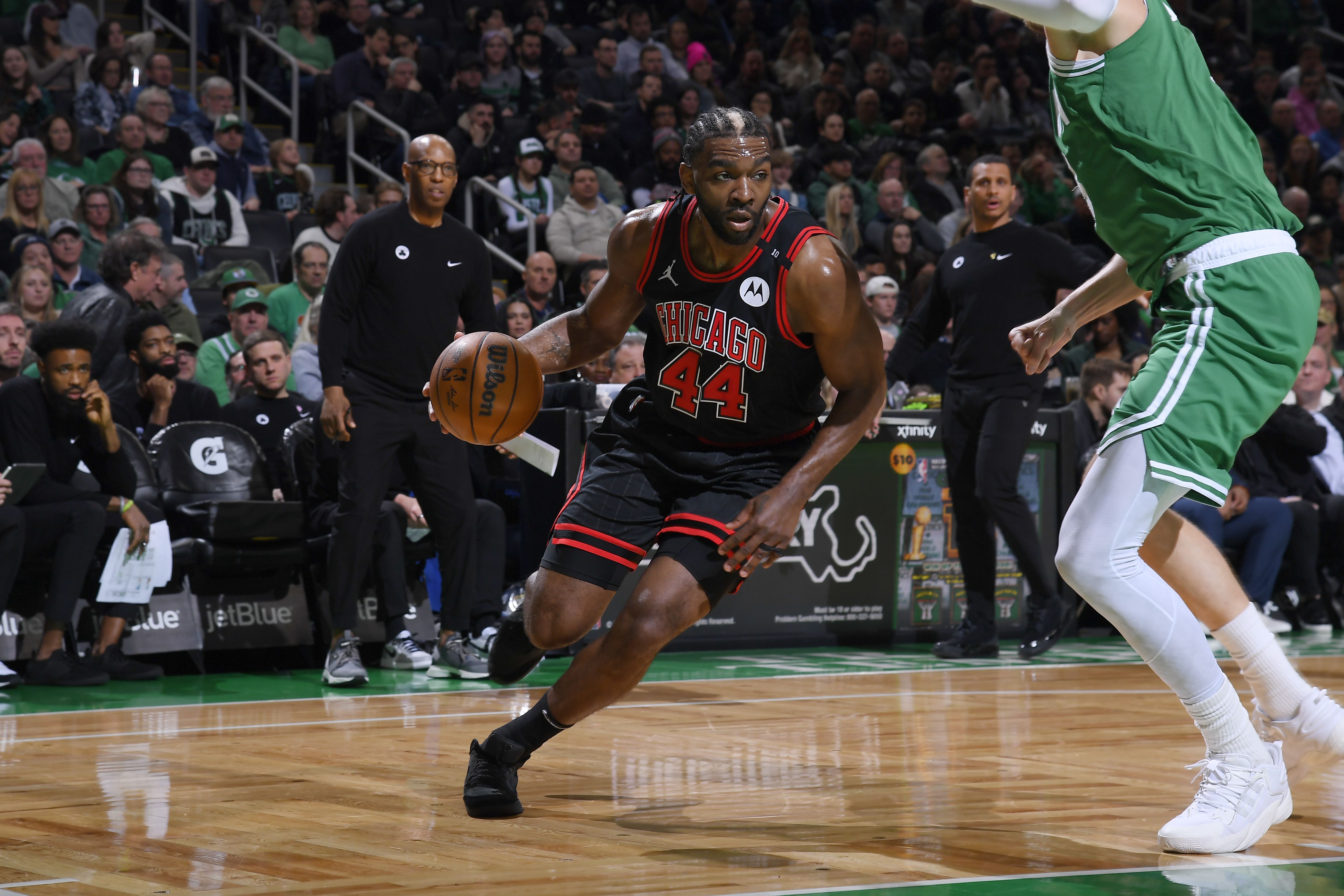 Photo of a man dribbling a basketball playing on a court 