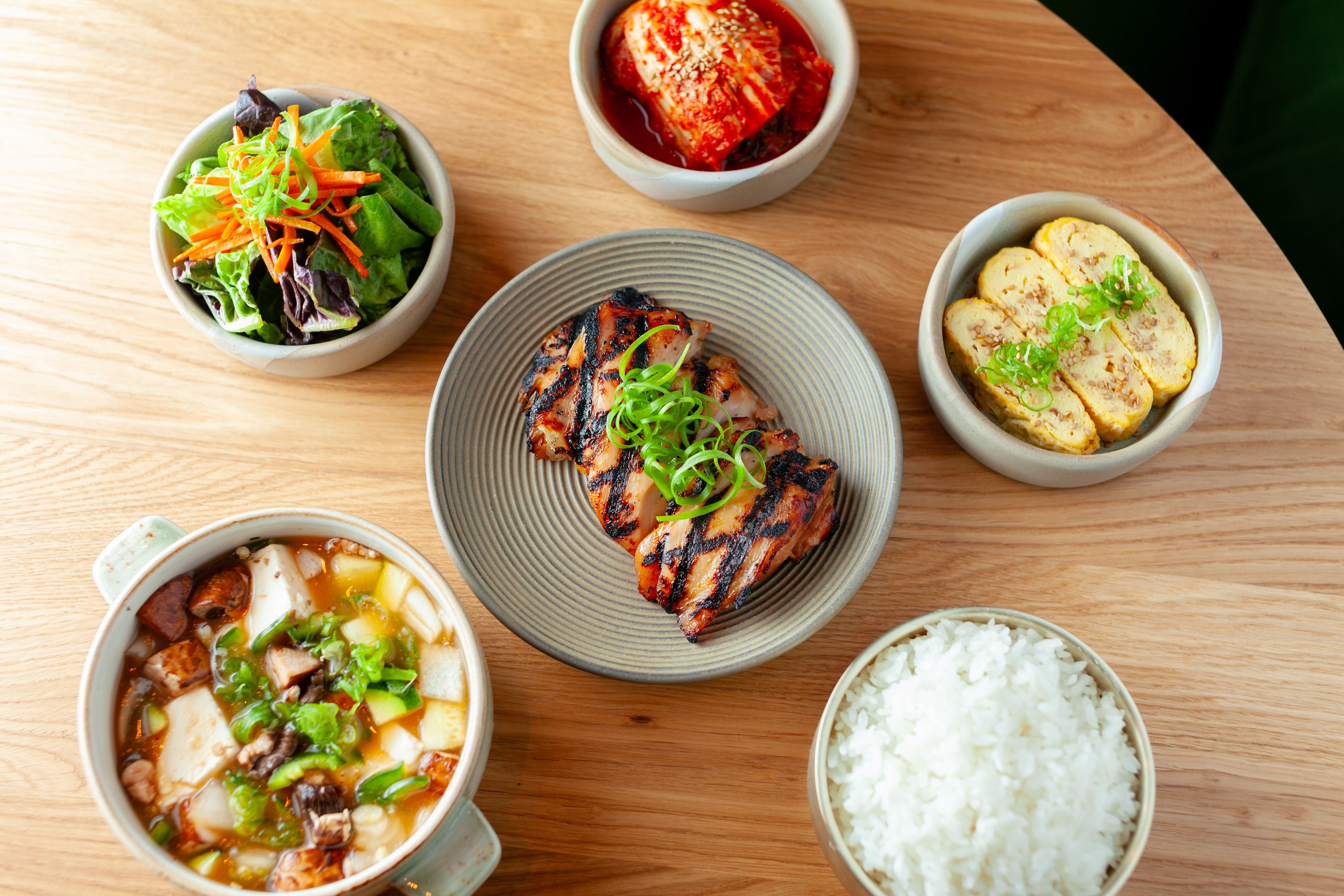 grilled chicken and small bowls around it