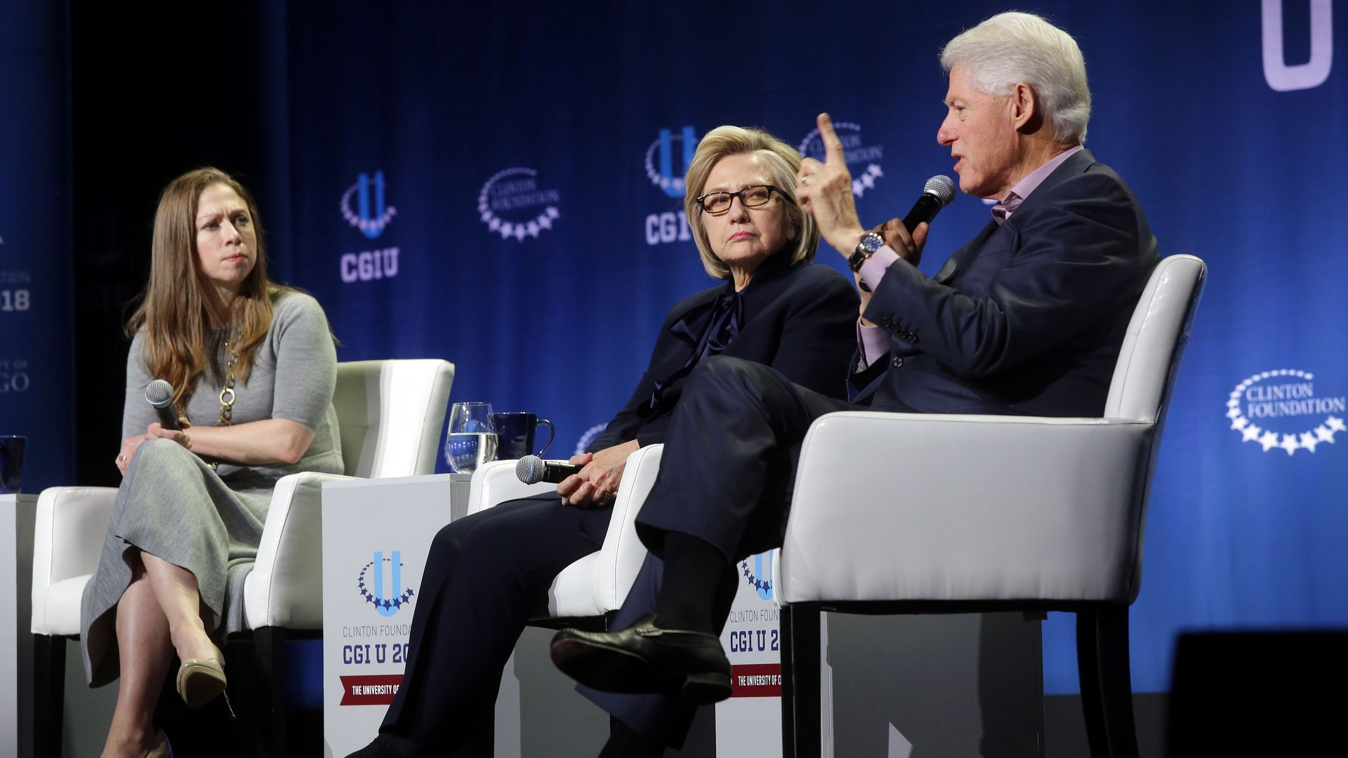 Bill, Hillary and Chelsea Clinton are seen at a 2018 event in Chicago staged by the Clinton Global Initiative.