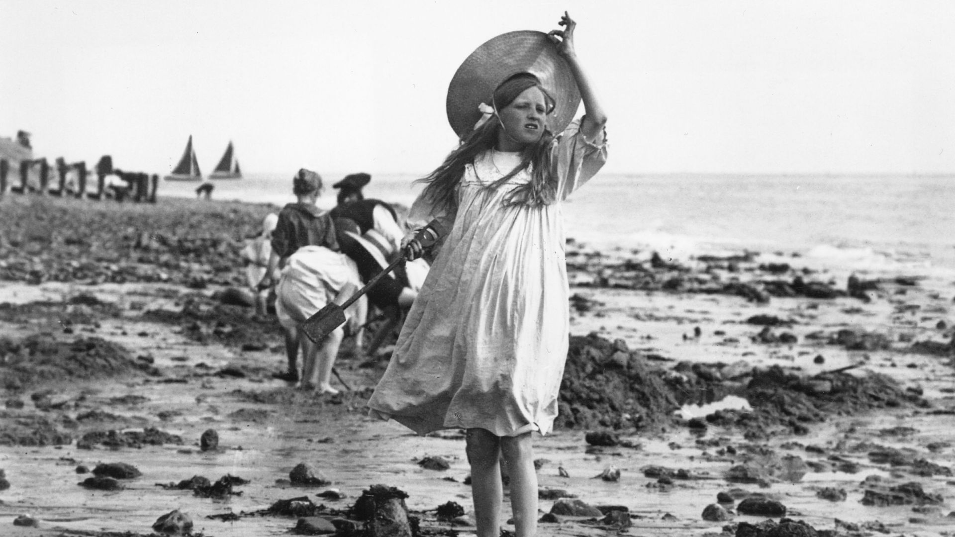 A girl looking confused at the beach