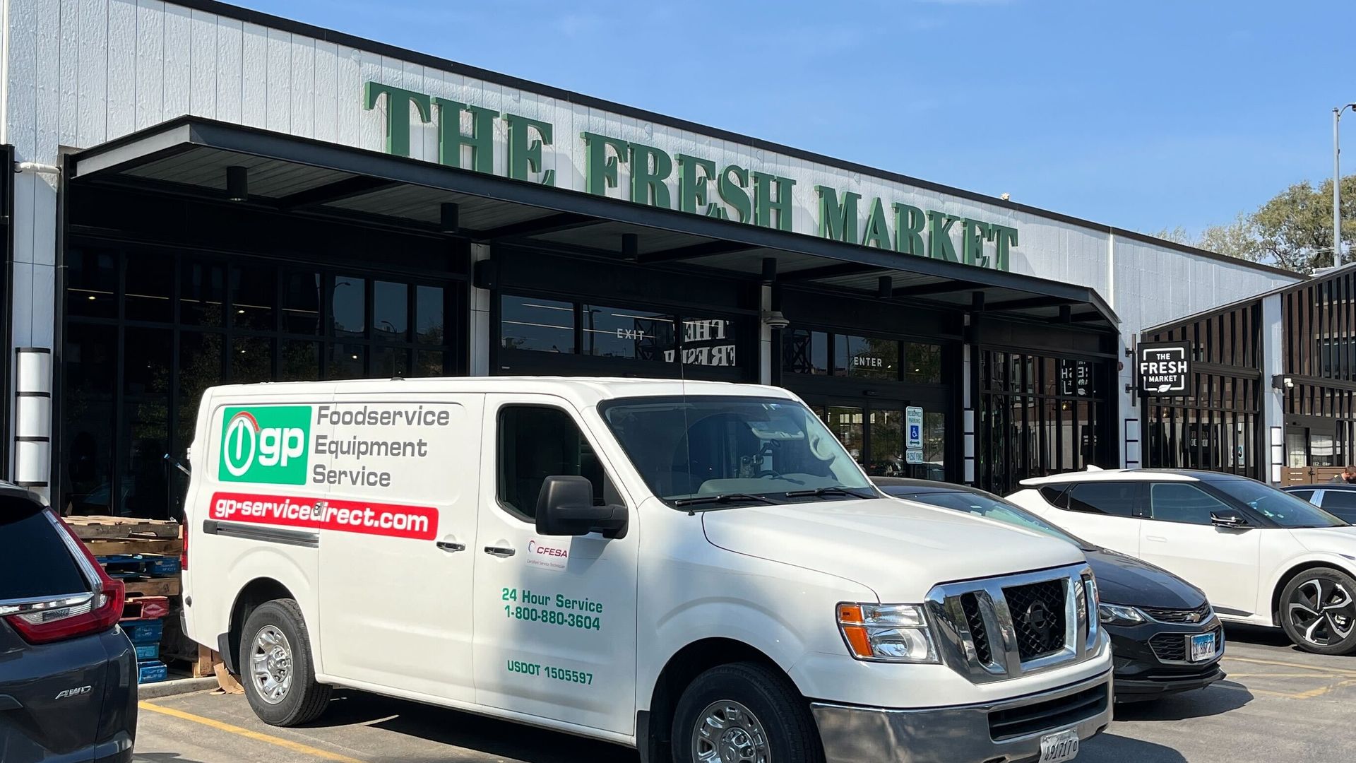 store with a van in front 