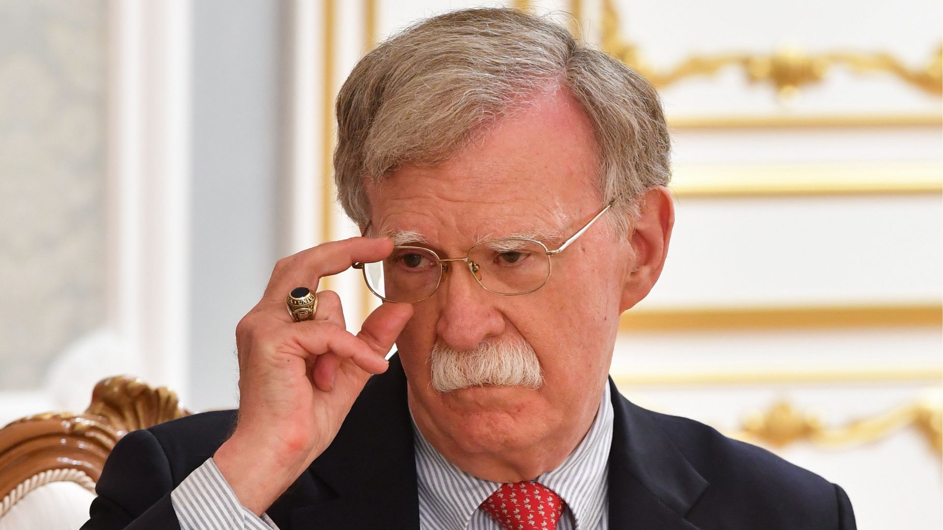 In this image, Bolton adjusts his glasses.