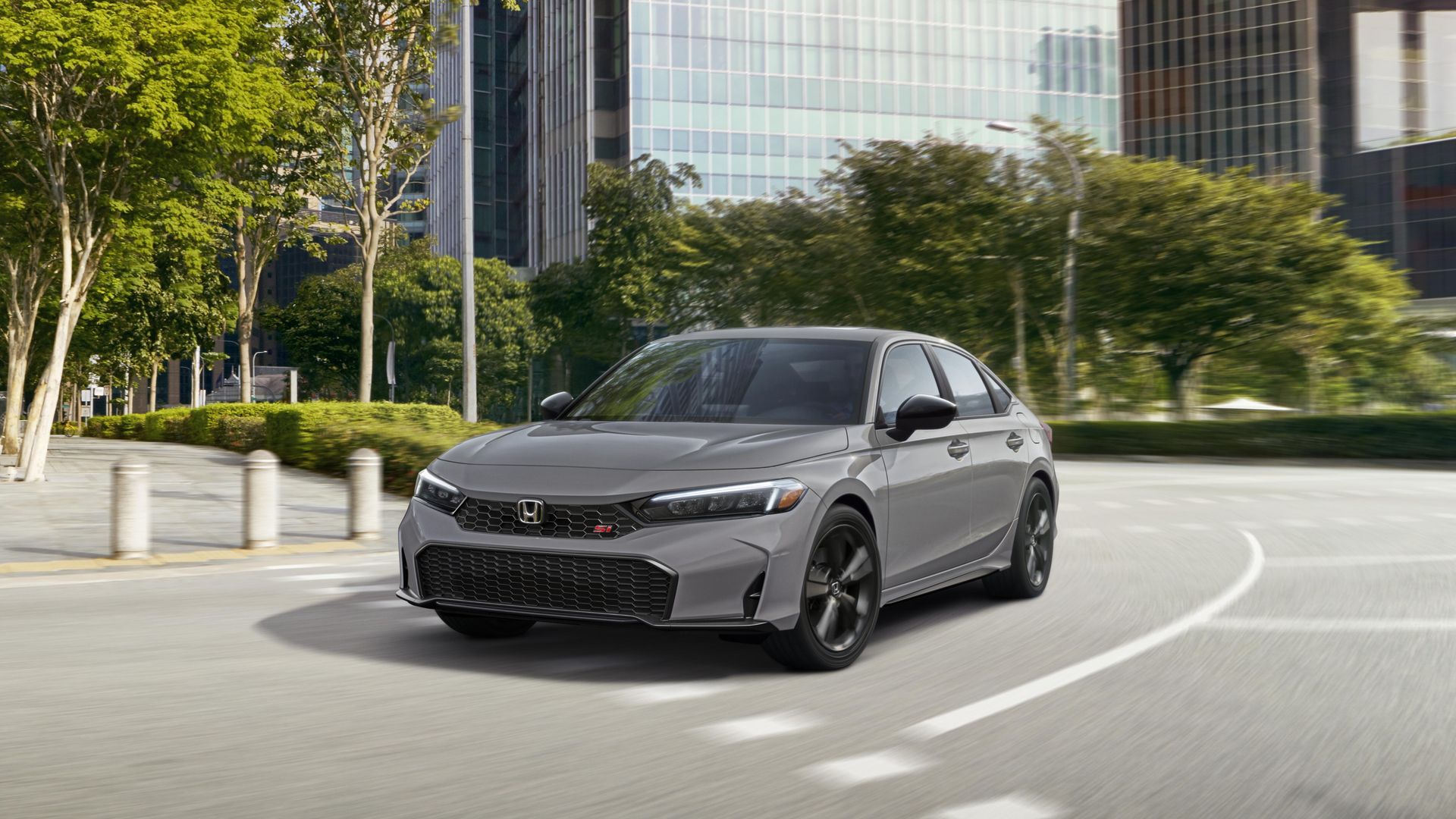 A gray vehicle curves around a road