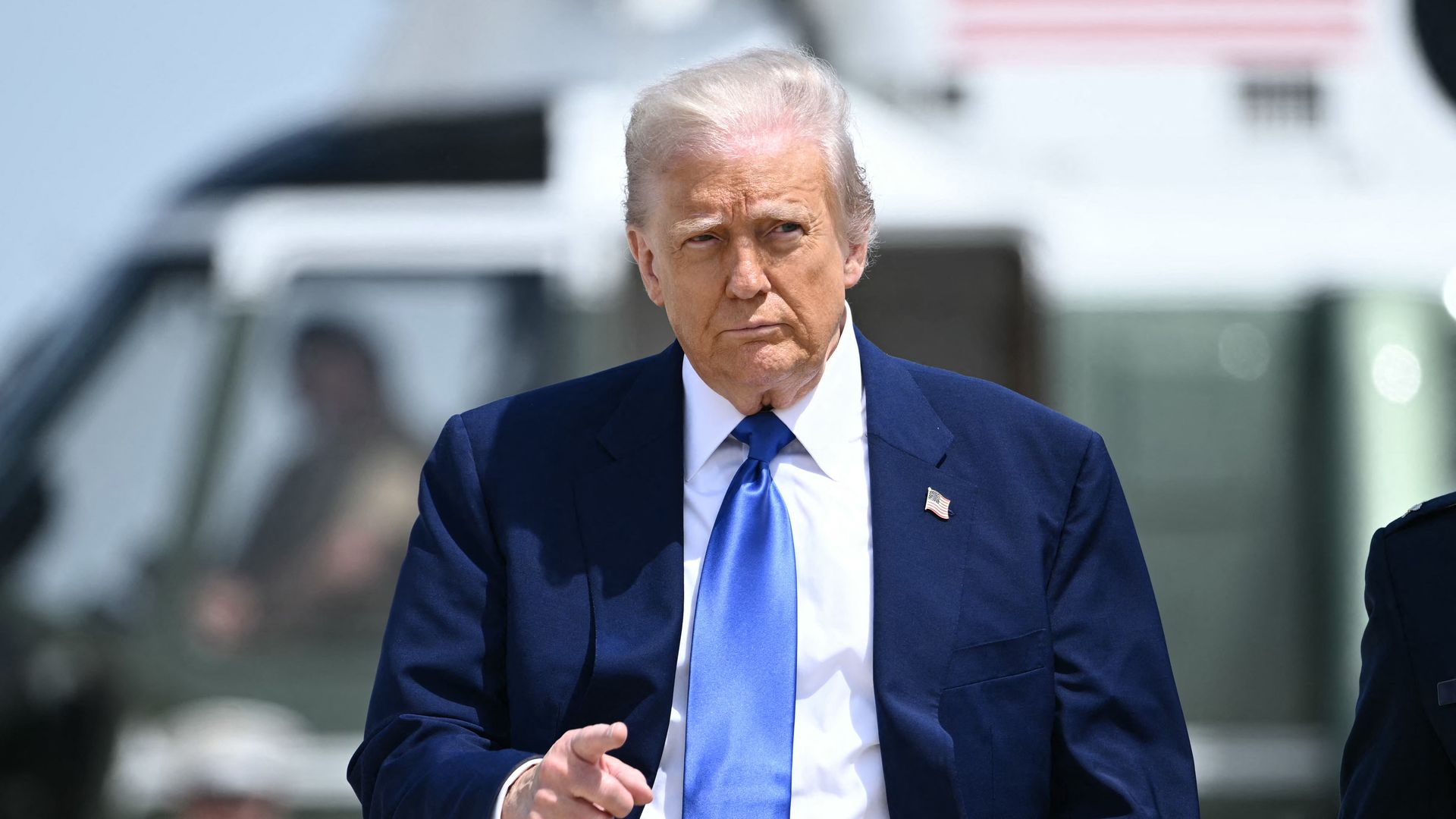  President Donald Trump gestures as he walks to Air Force One at Joint Base Andrews in Maryland on May 12, 2025. 