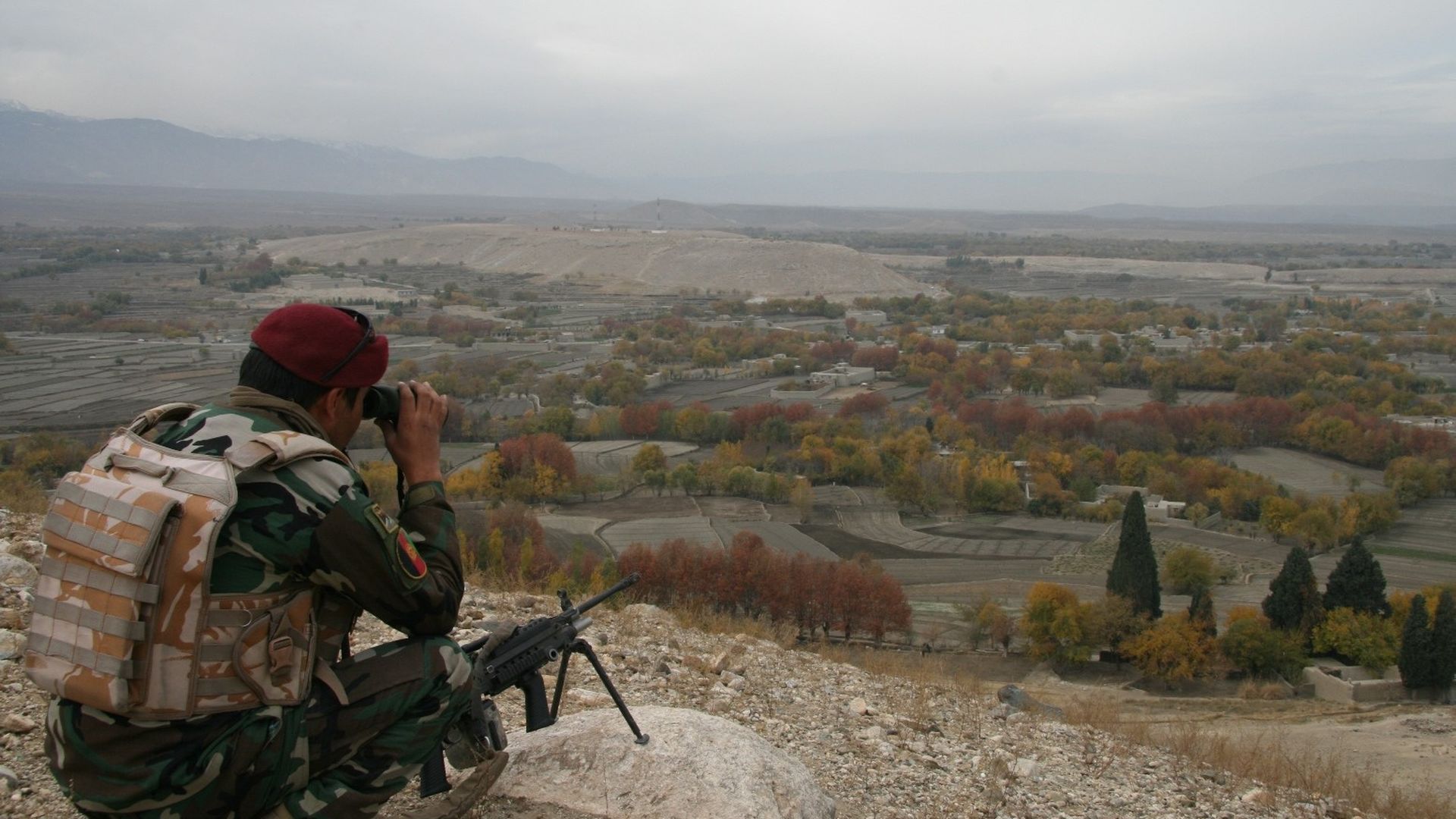Security force fighter looks through binoculars