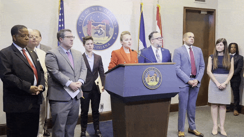 Image shows Helena Moreno and other New Orleans officials talking behind a podium.
