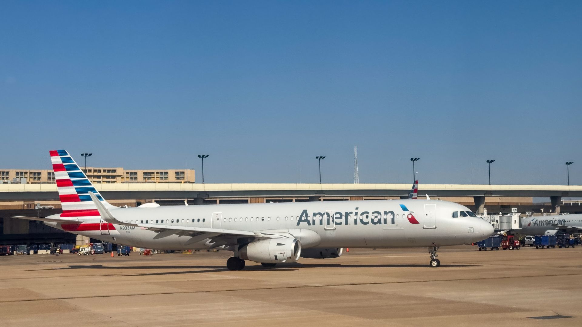 An American Airlines plane drives on the runway leaving the terminal at DFW Airport. 
