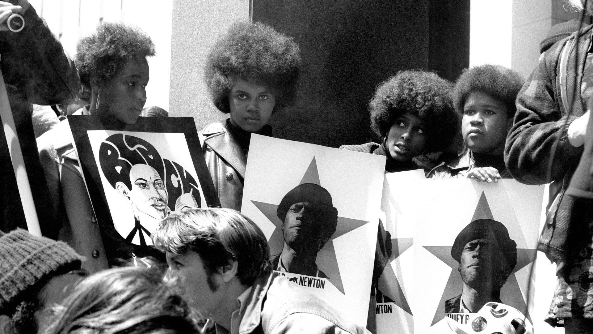 black women holding posters