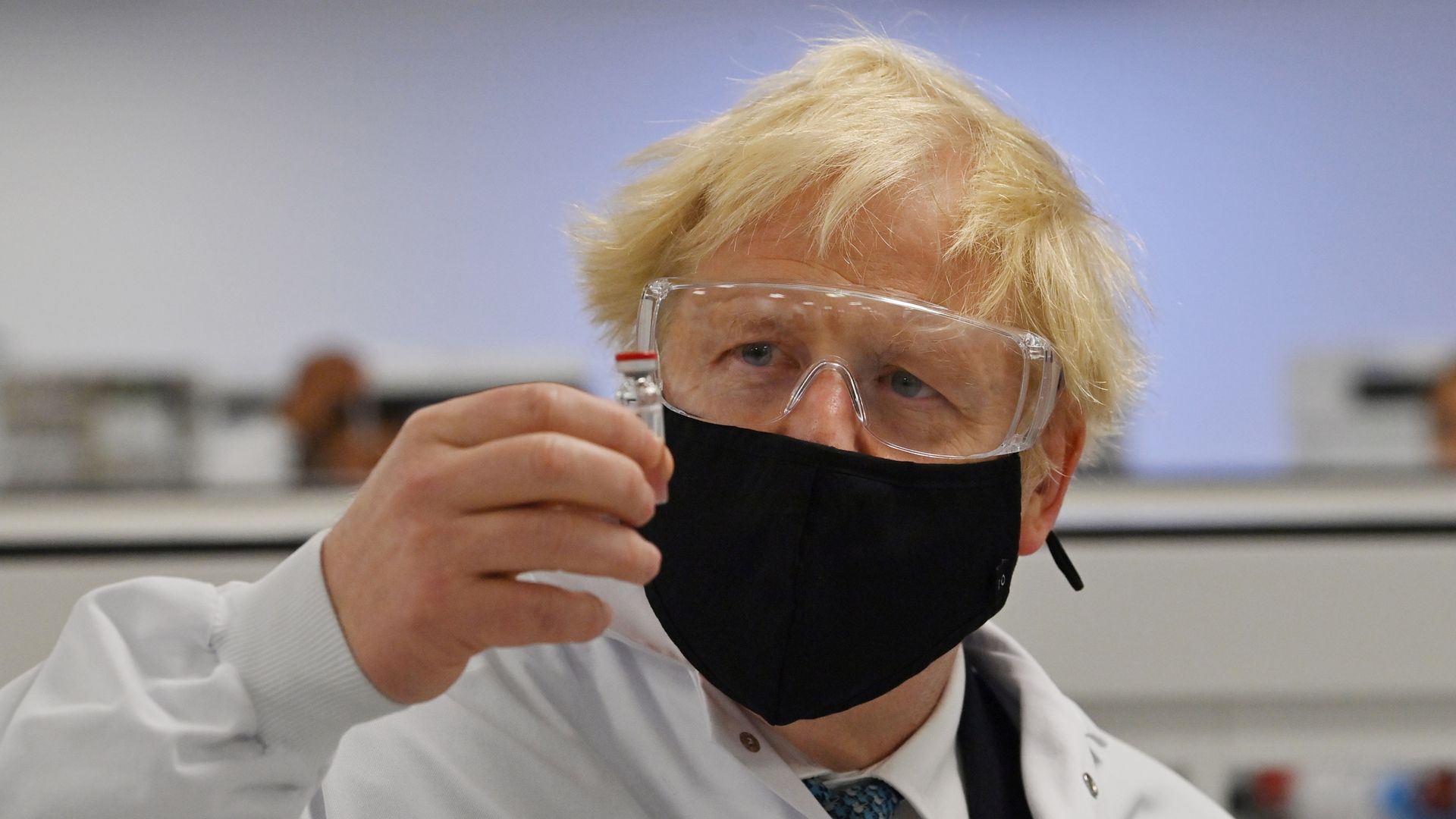 Boris Johnson holding vial