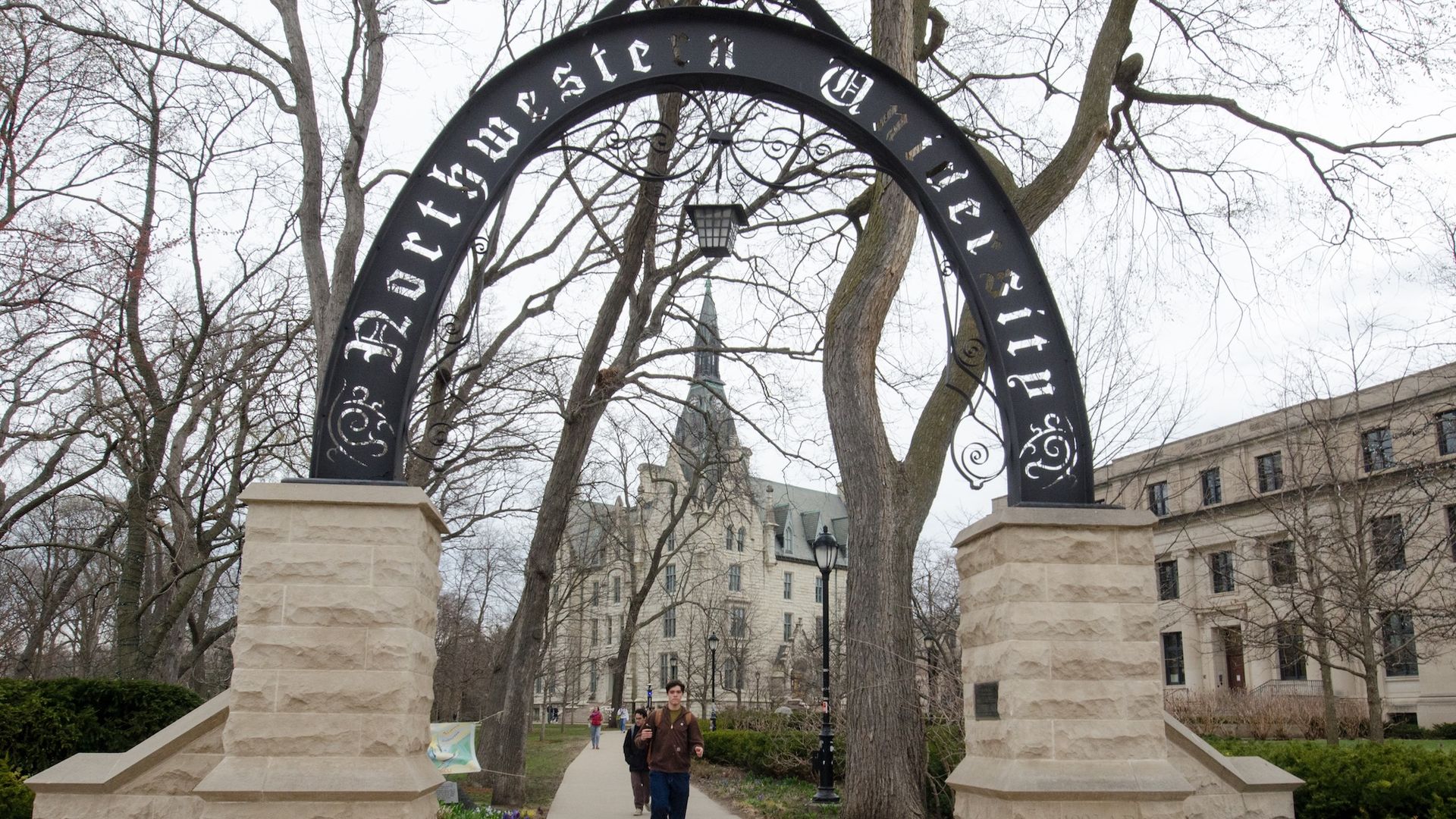 Iron arch with Northwestern university carved into it on top of limestone pedestals