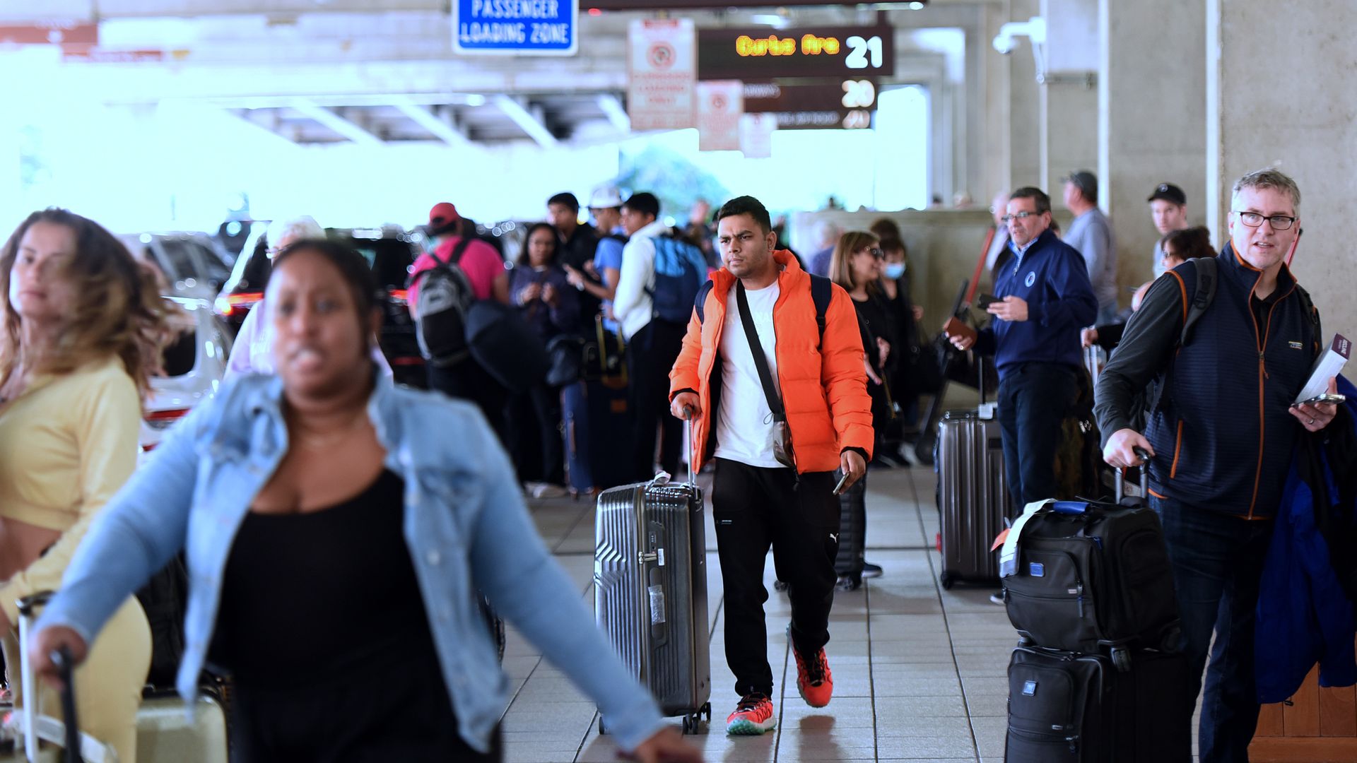 Arriving travelers wait for ground transportation during the busy Christmas holiday season at Orlando International Airport on December 28, 2022 in Orlando, Florida.