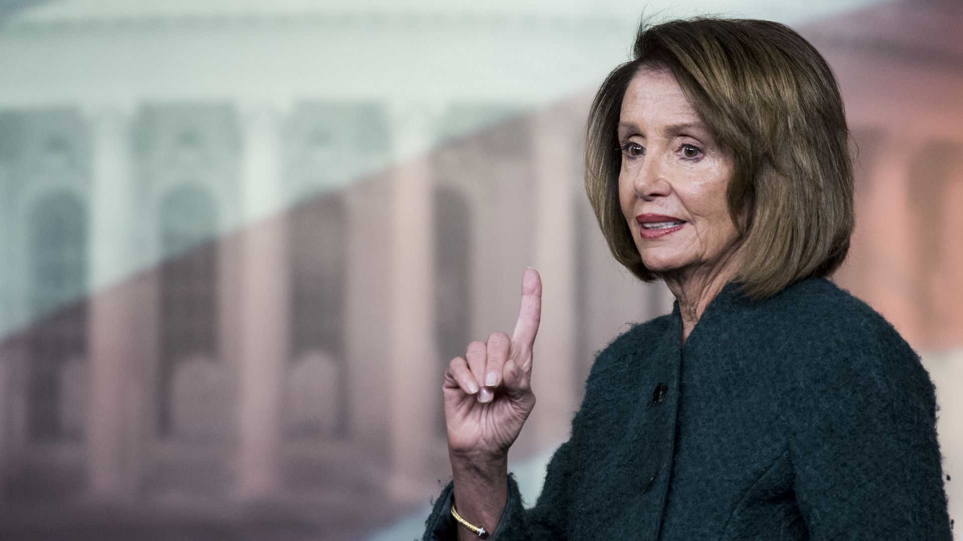 Nancy Pelosi in green pantsuit