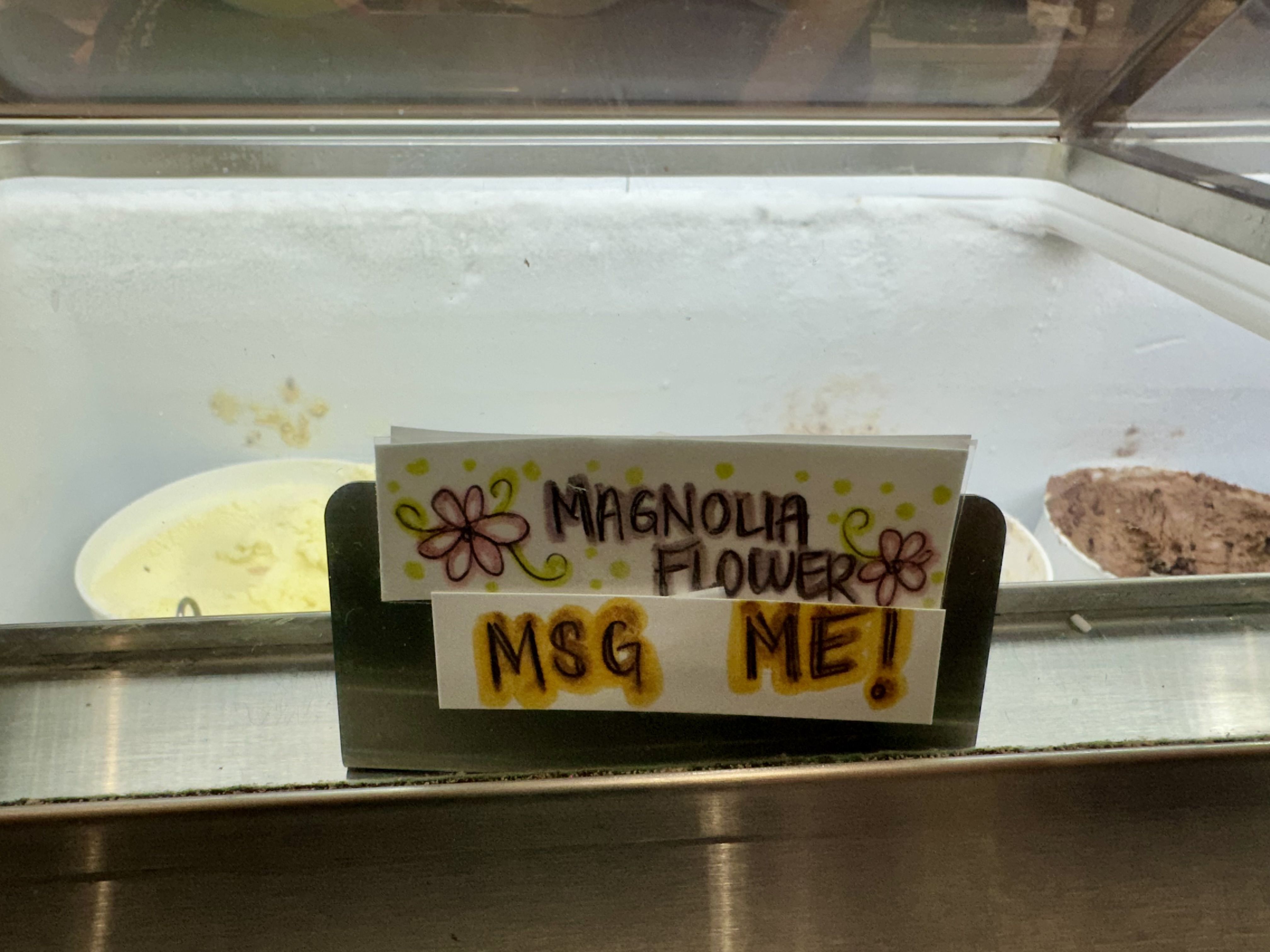 sign says "magnolia flower" and "MSG ME!"