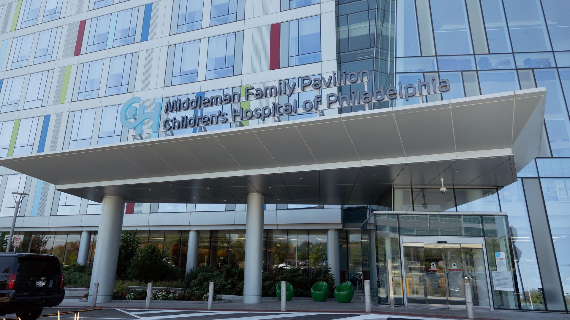 Entrance of Middleman Family Pavilion at Children's Hospital of Philadelphia, a modern building with glass windows and colorful vertical stripes on the facade.