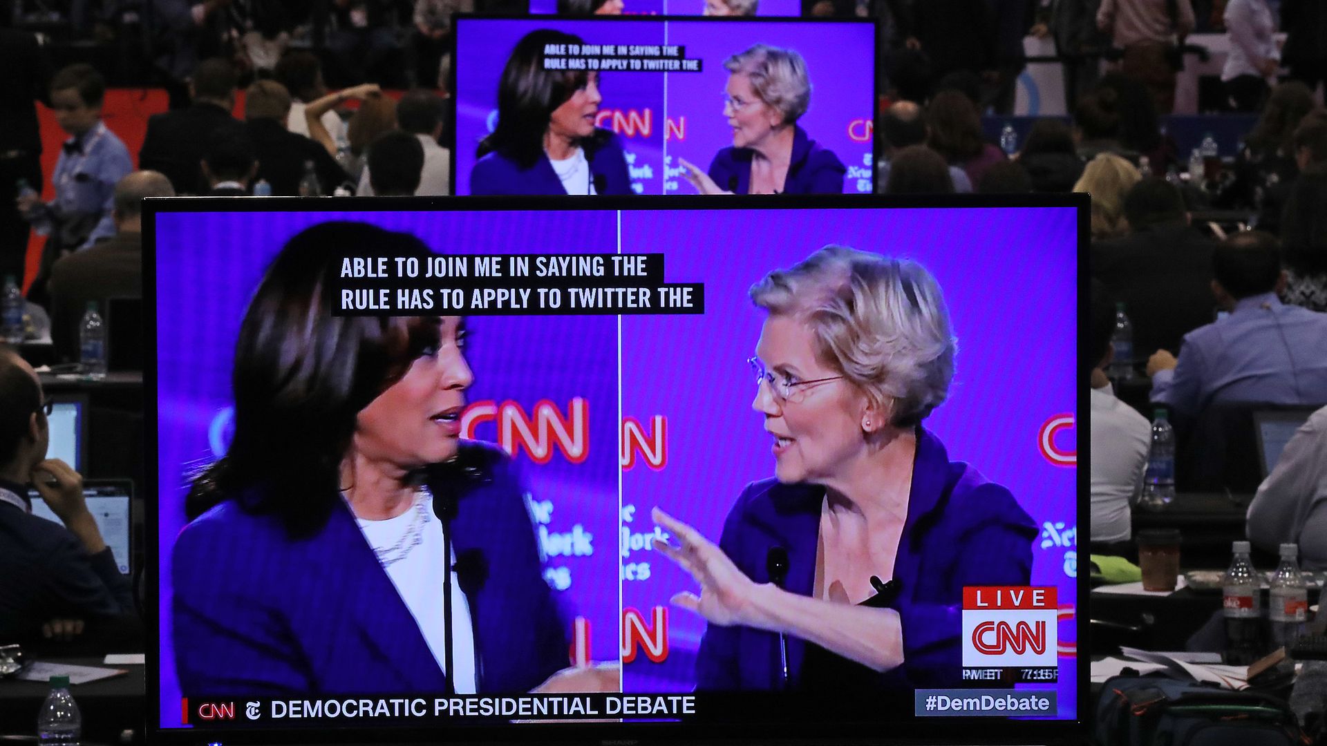 Photo of Sens. Kamala Harris and Elizabeth Warren debating on a screen 