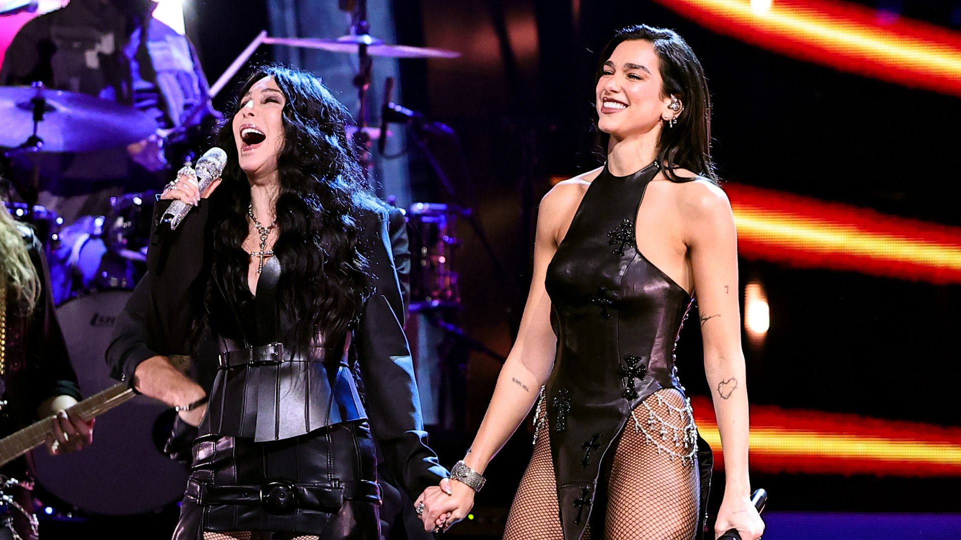 Dua Lipa and Cher perform on stage together.