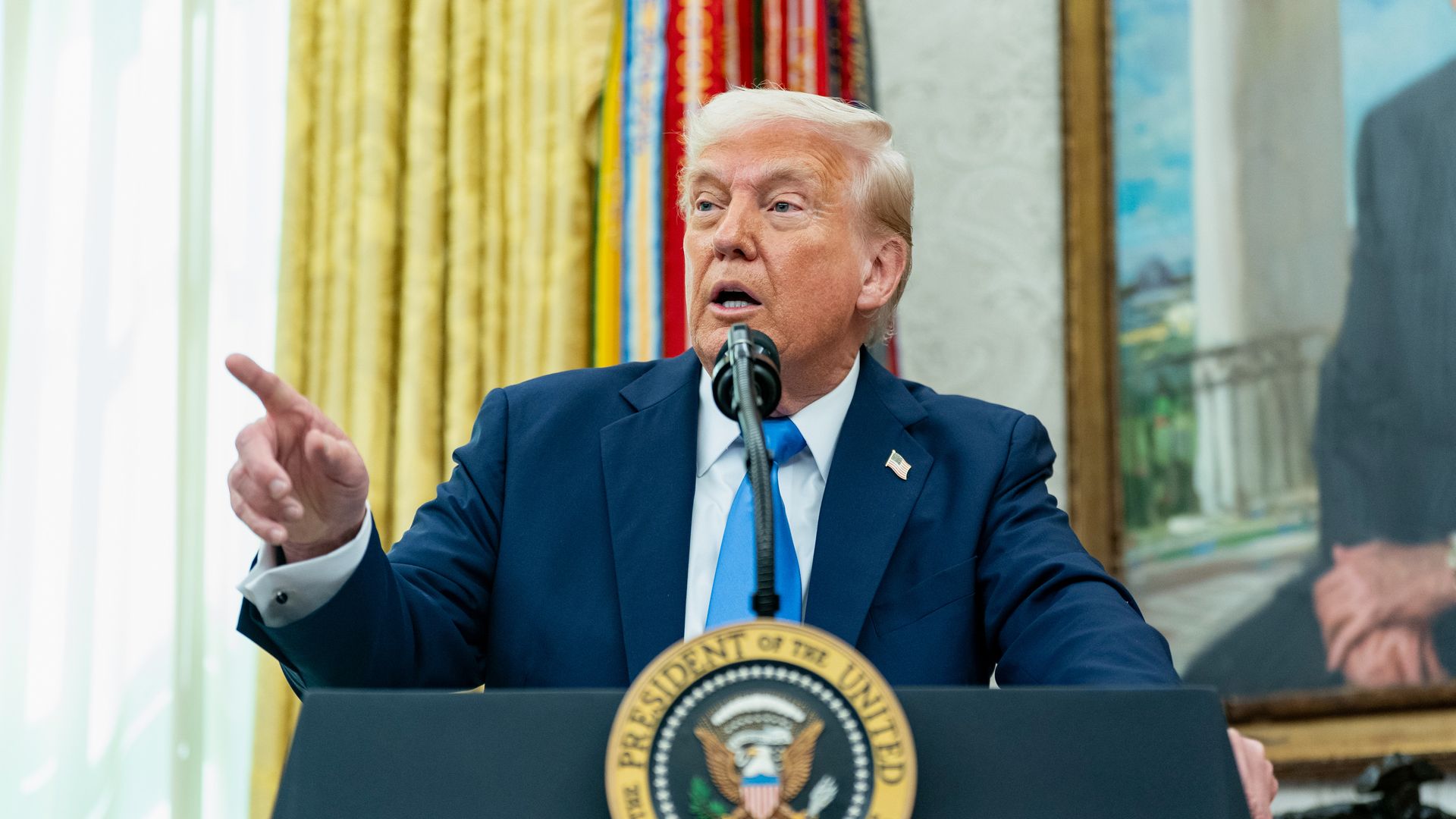 Photo of Donald Trump speaking from a podium while gesturing with a finger