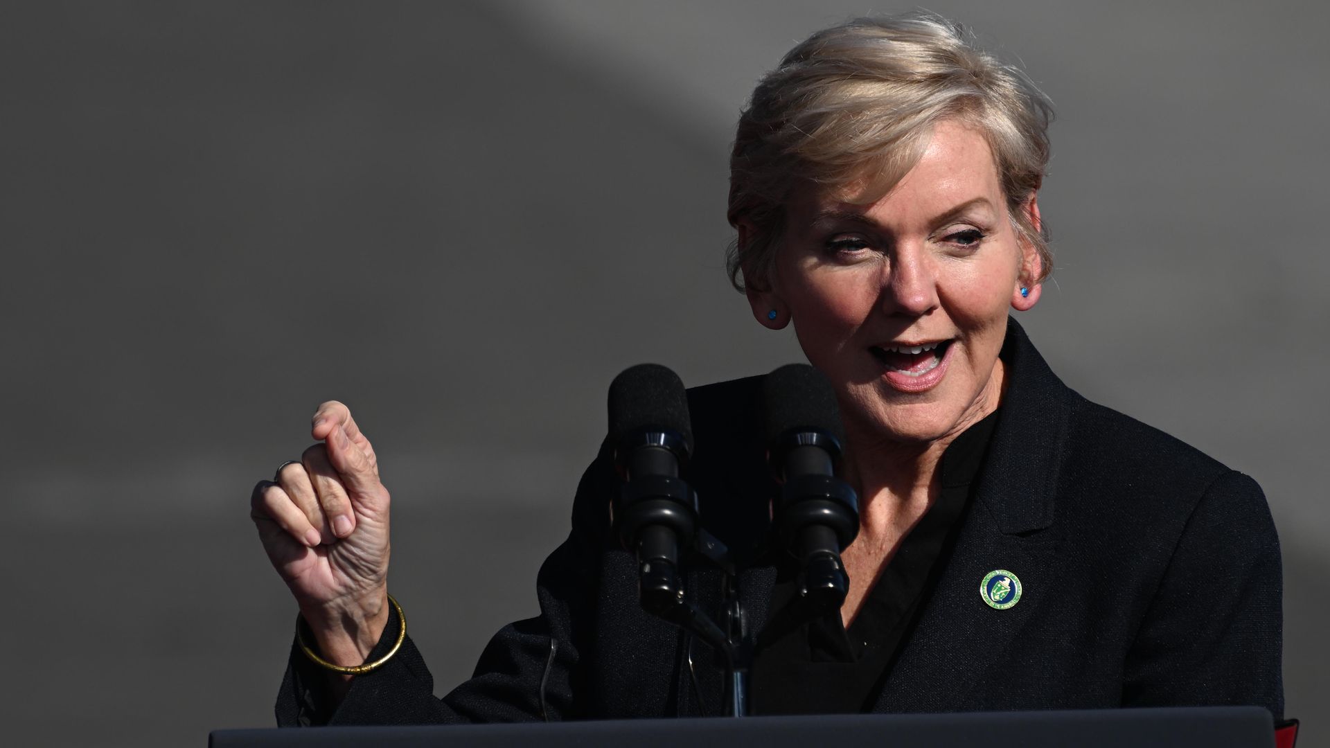 Photo shows Jennifer Granhold speaking behind a podium
