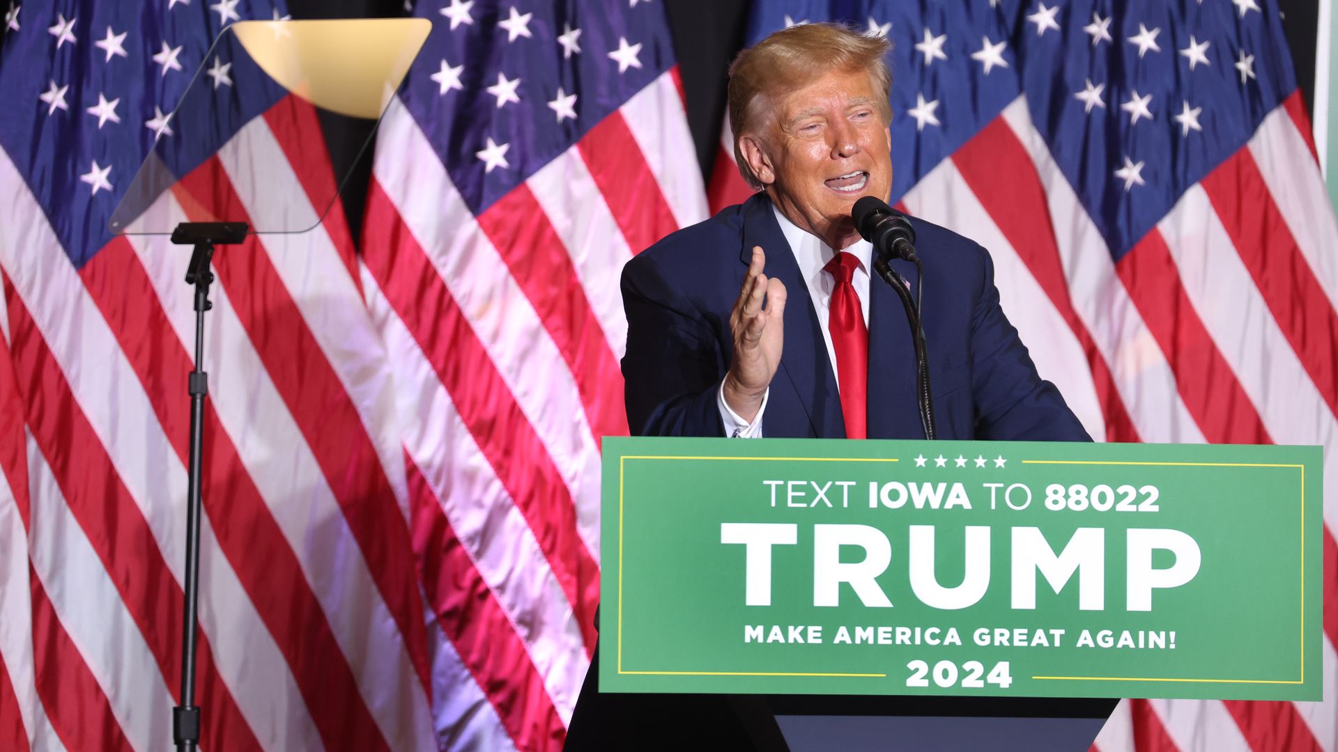 Donald Trump speaking at a podium