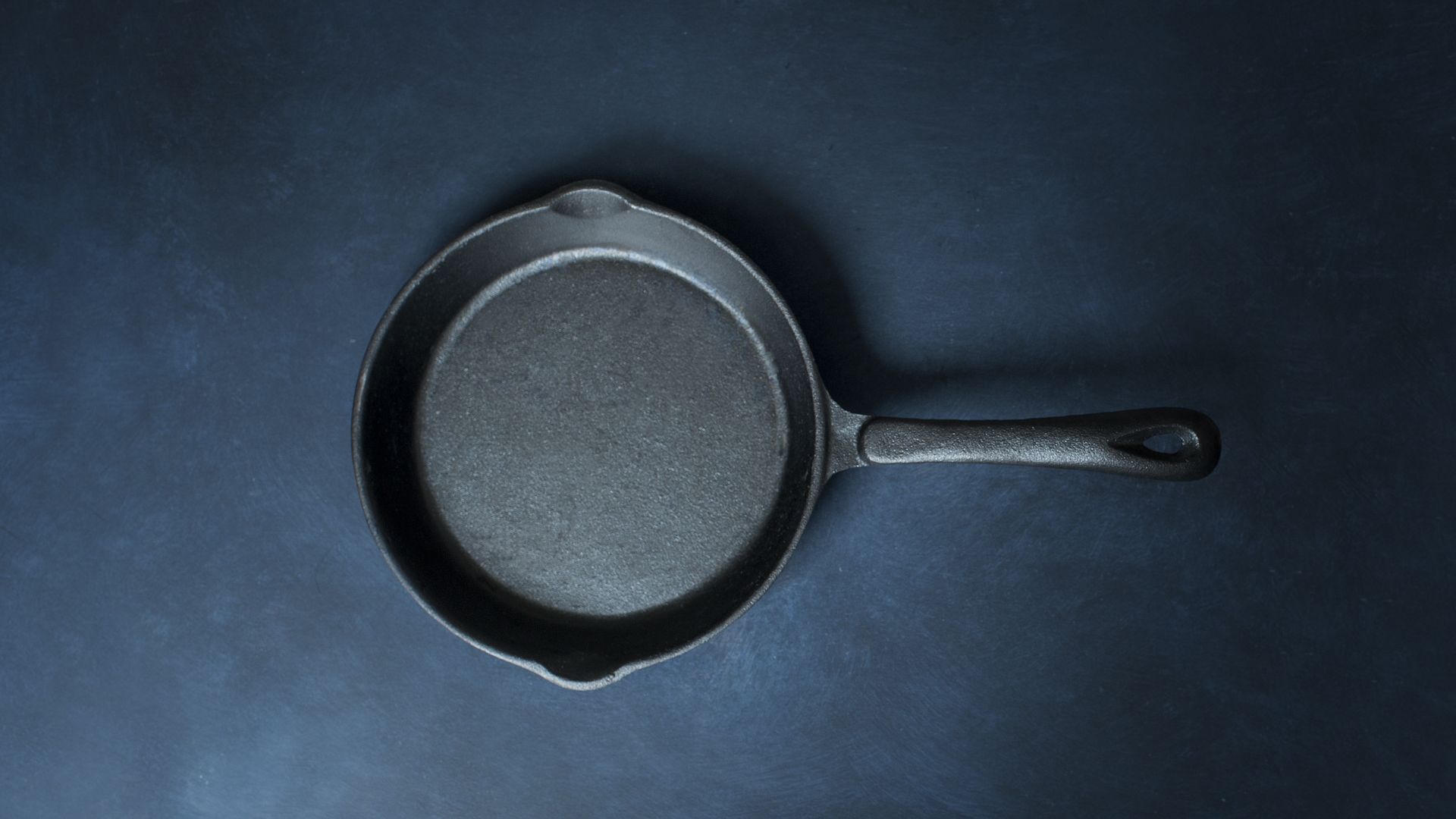 stock photo of a skillet against a blue background