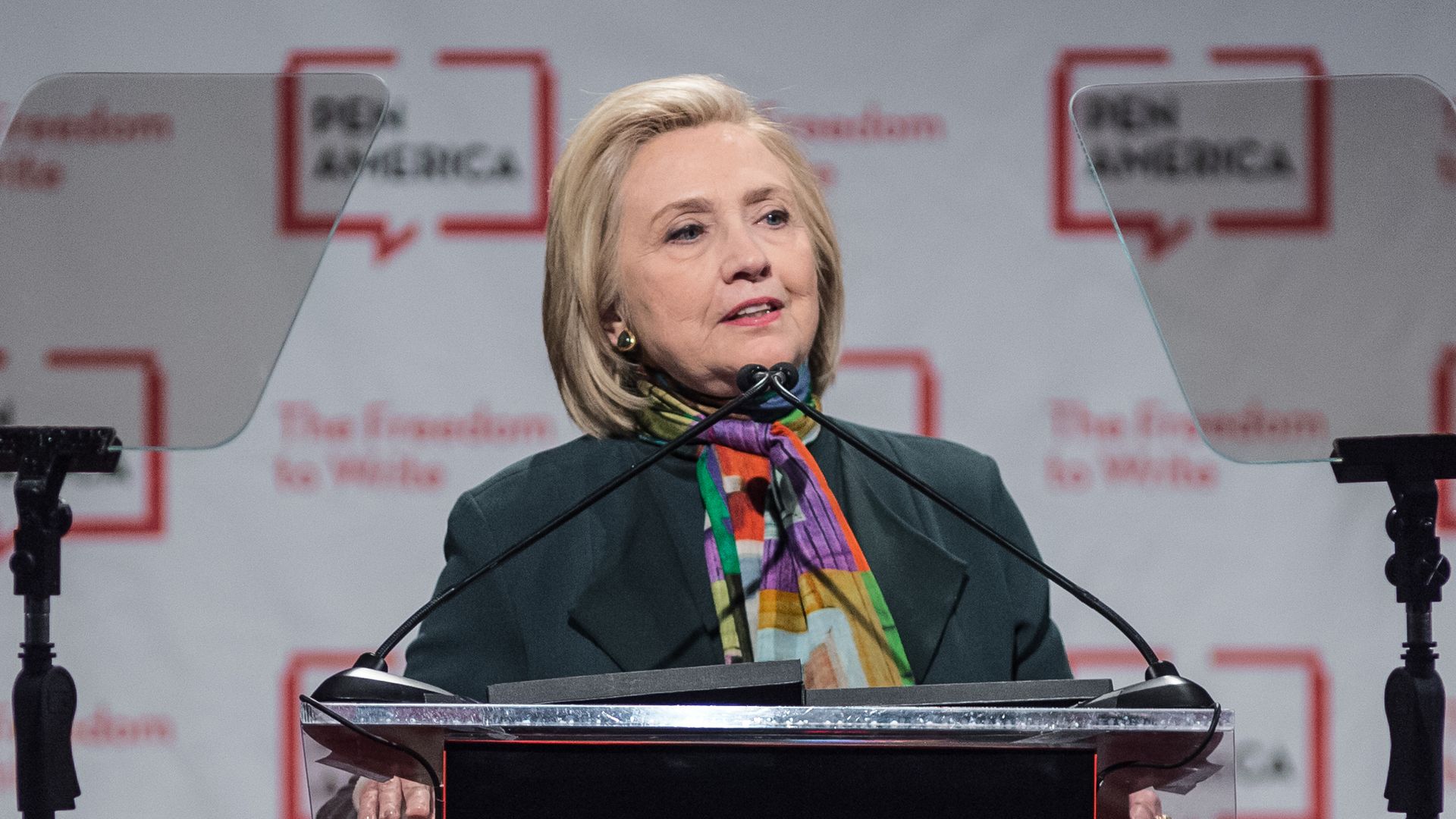 Clinton stands behind a podium