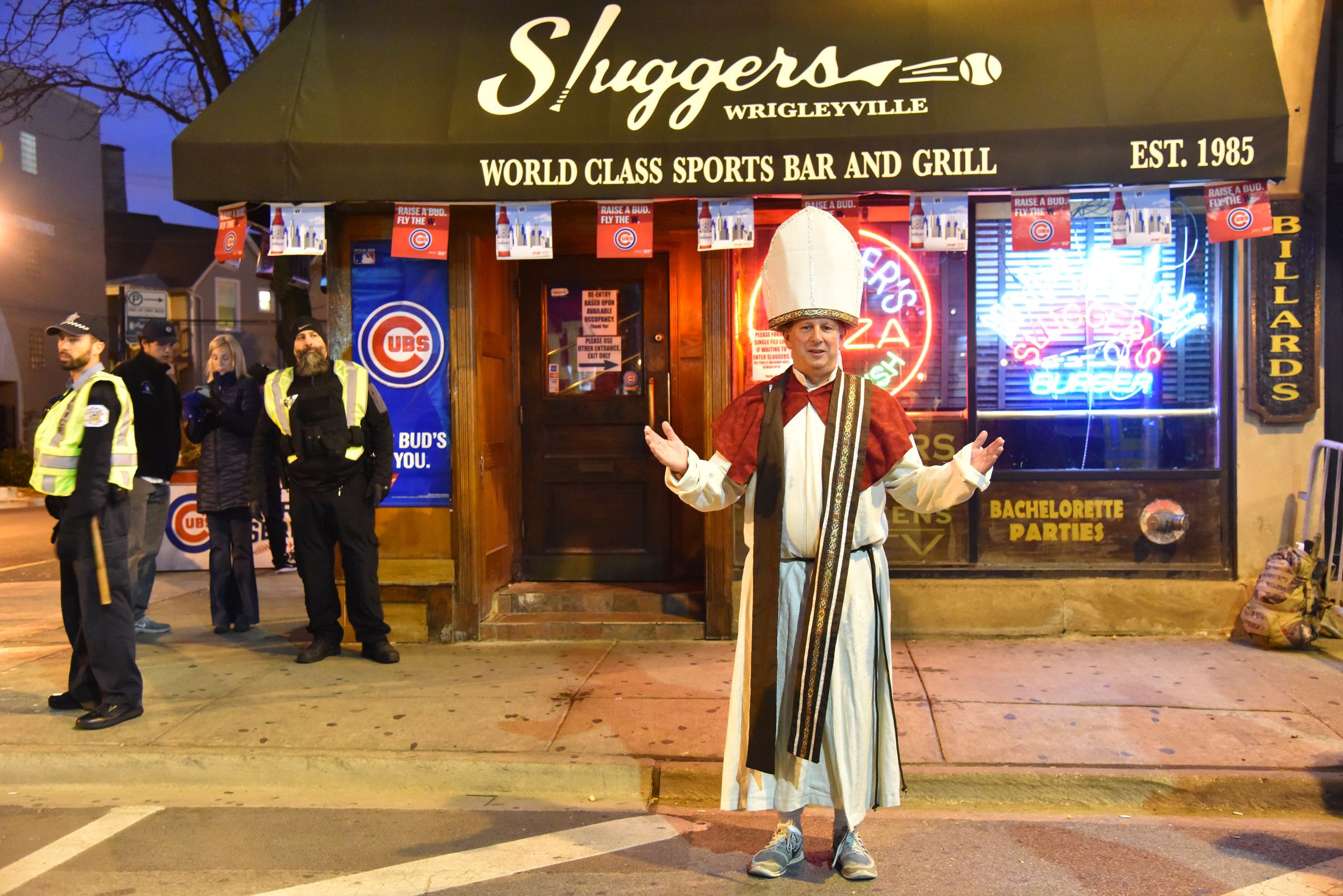 Man dressed as a pope outside a bar