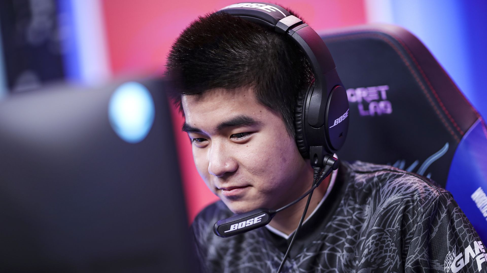 An esports player looks at their monitor as they play a video game