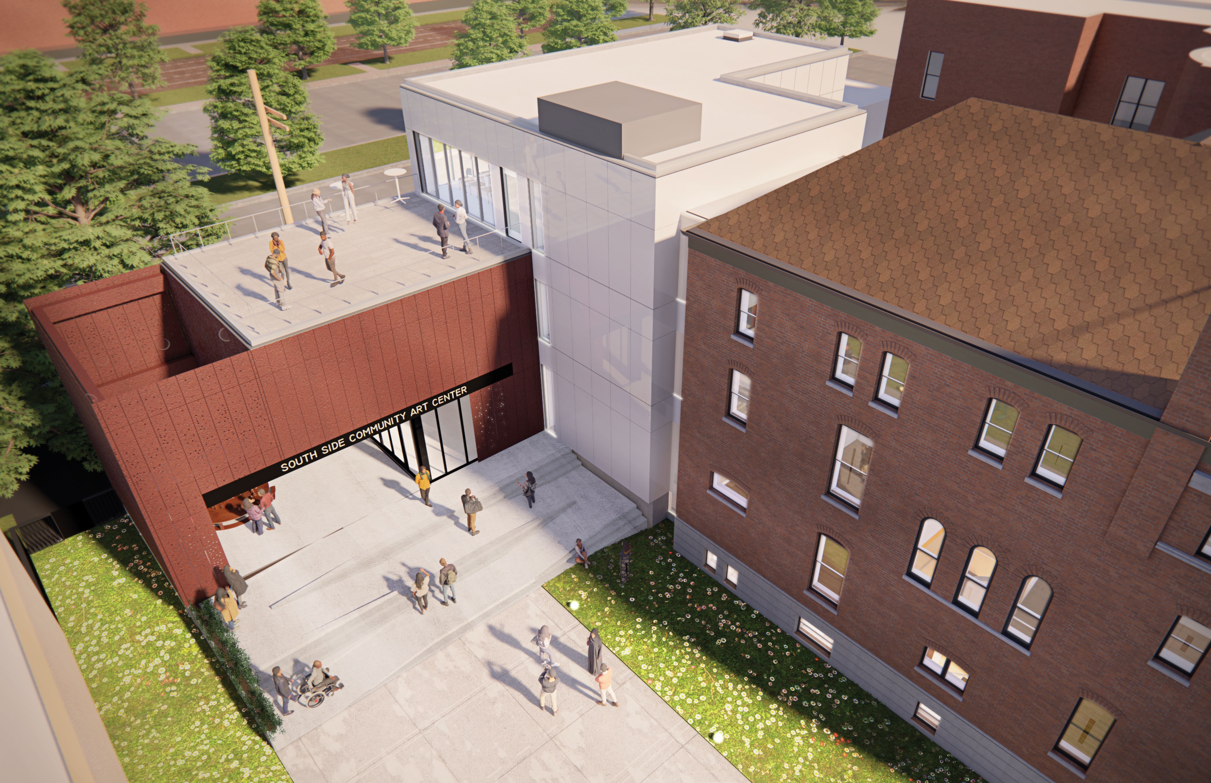 An aerial view of an old brick building next to new construction.