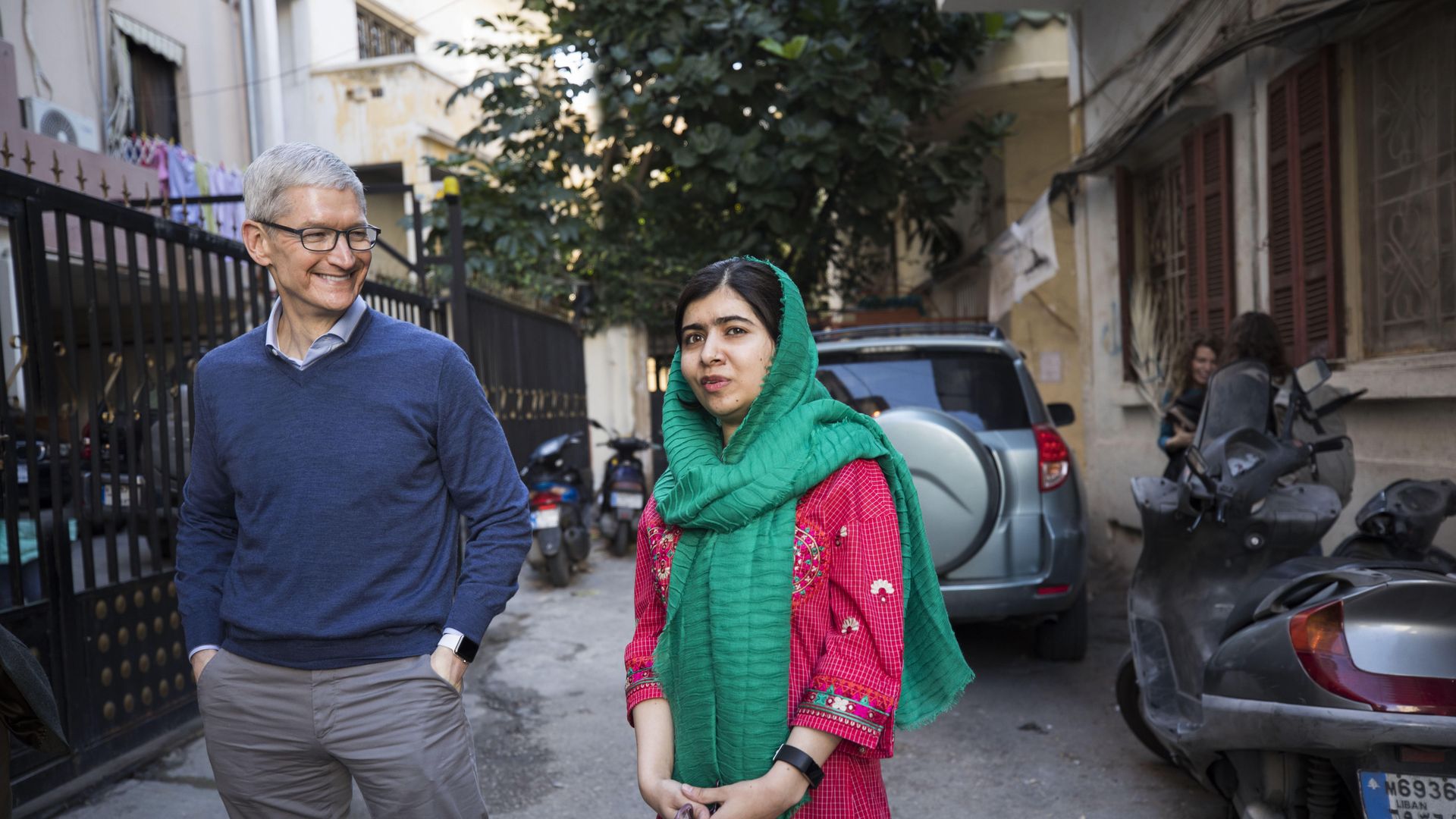 Tim Cook and Malala Yousafzai outside the home of a family with daughters attending school in Beirut supported by the Malala Fund