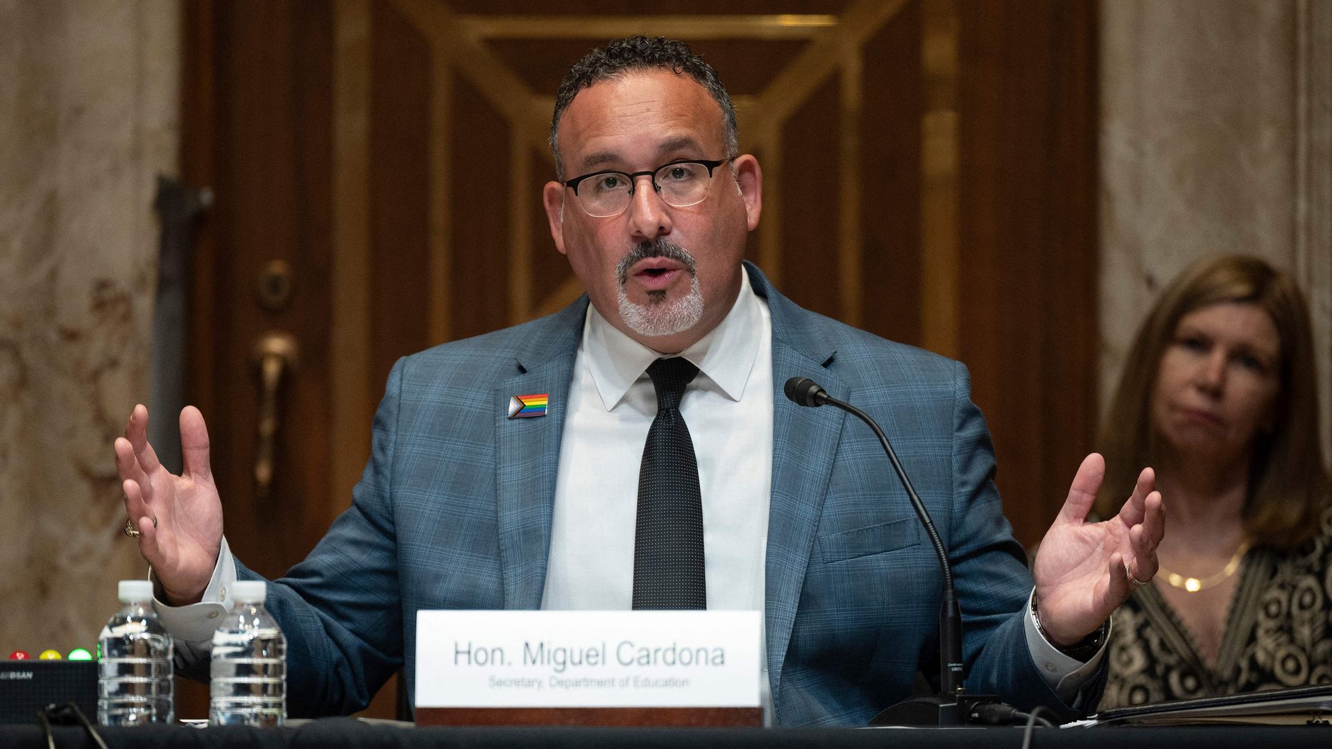 Education Secretary Miguel Cardona is seen speaking during a congressional hearing.