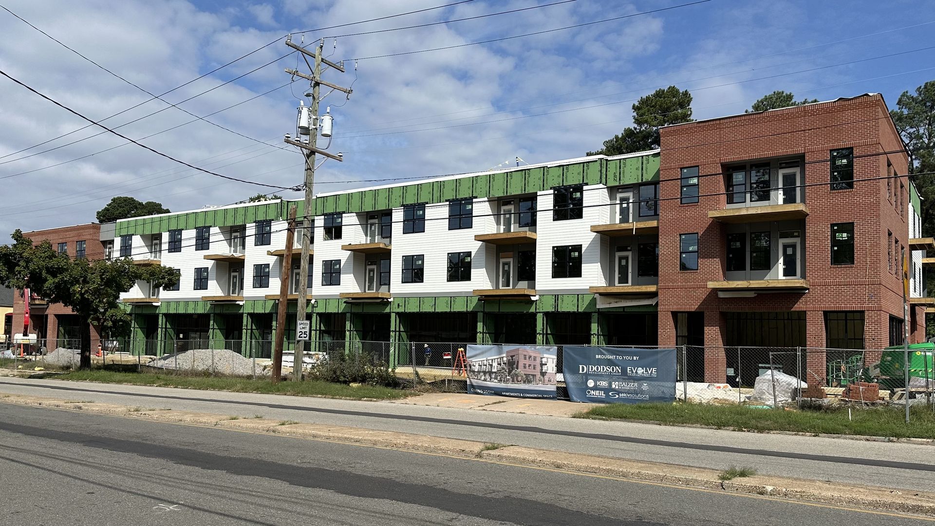 a long, three-story building under construction 