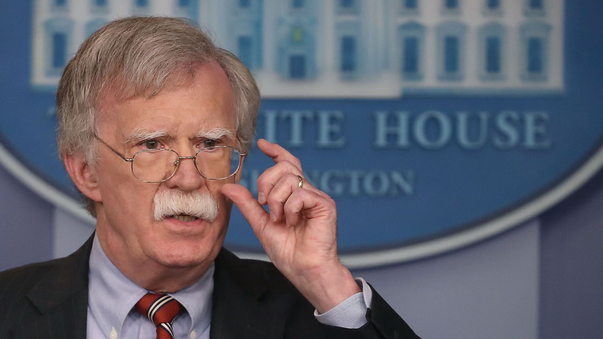 John Bolton at the White House, with his hand near his glasses