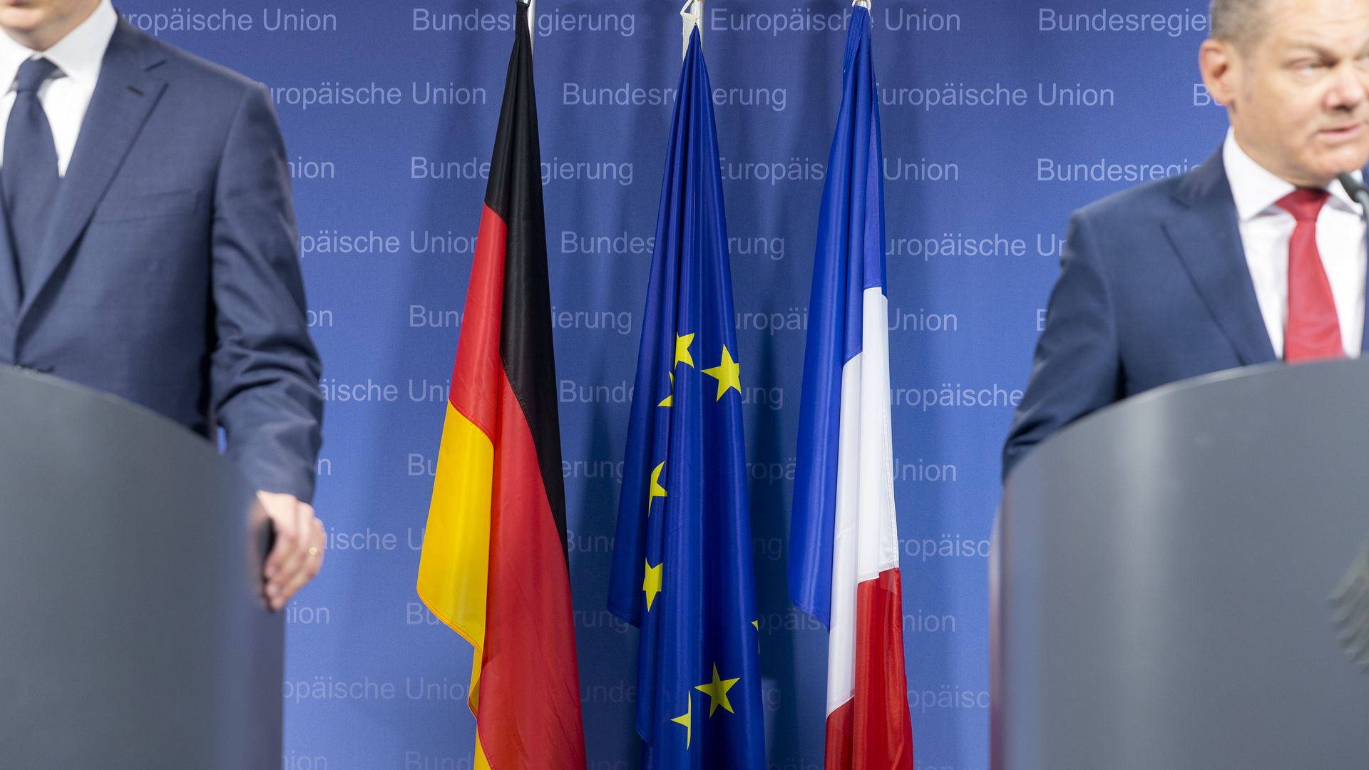 Germany, EU, and France flags in between podiums