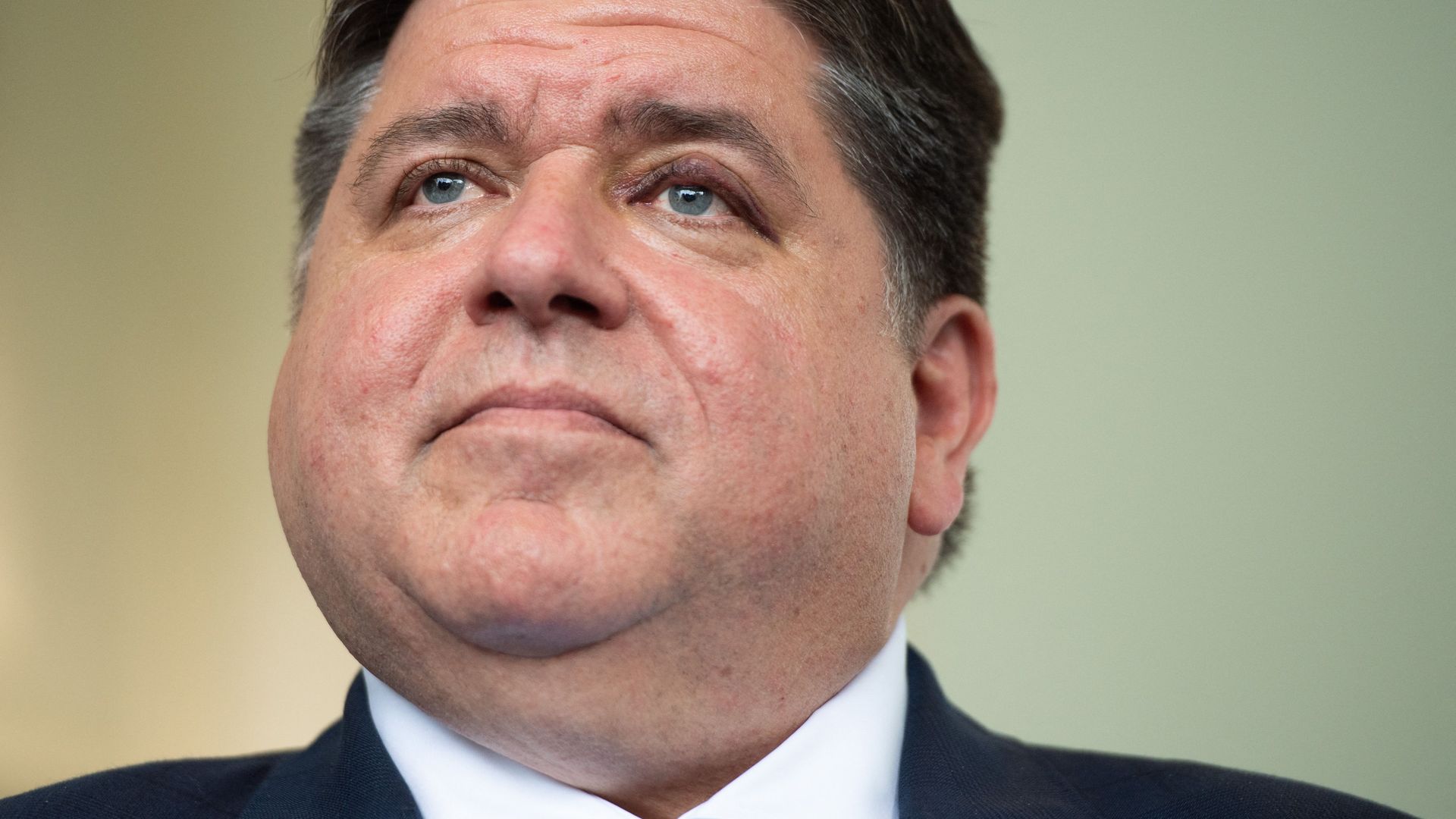 Photo of close-up of Gov Pritzker's face. 