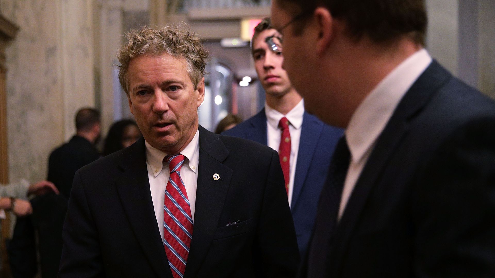 Rand Paul in suit and red tie. 
