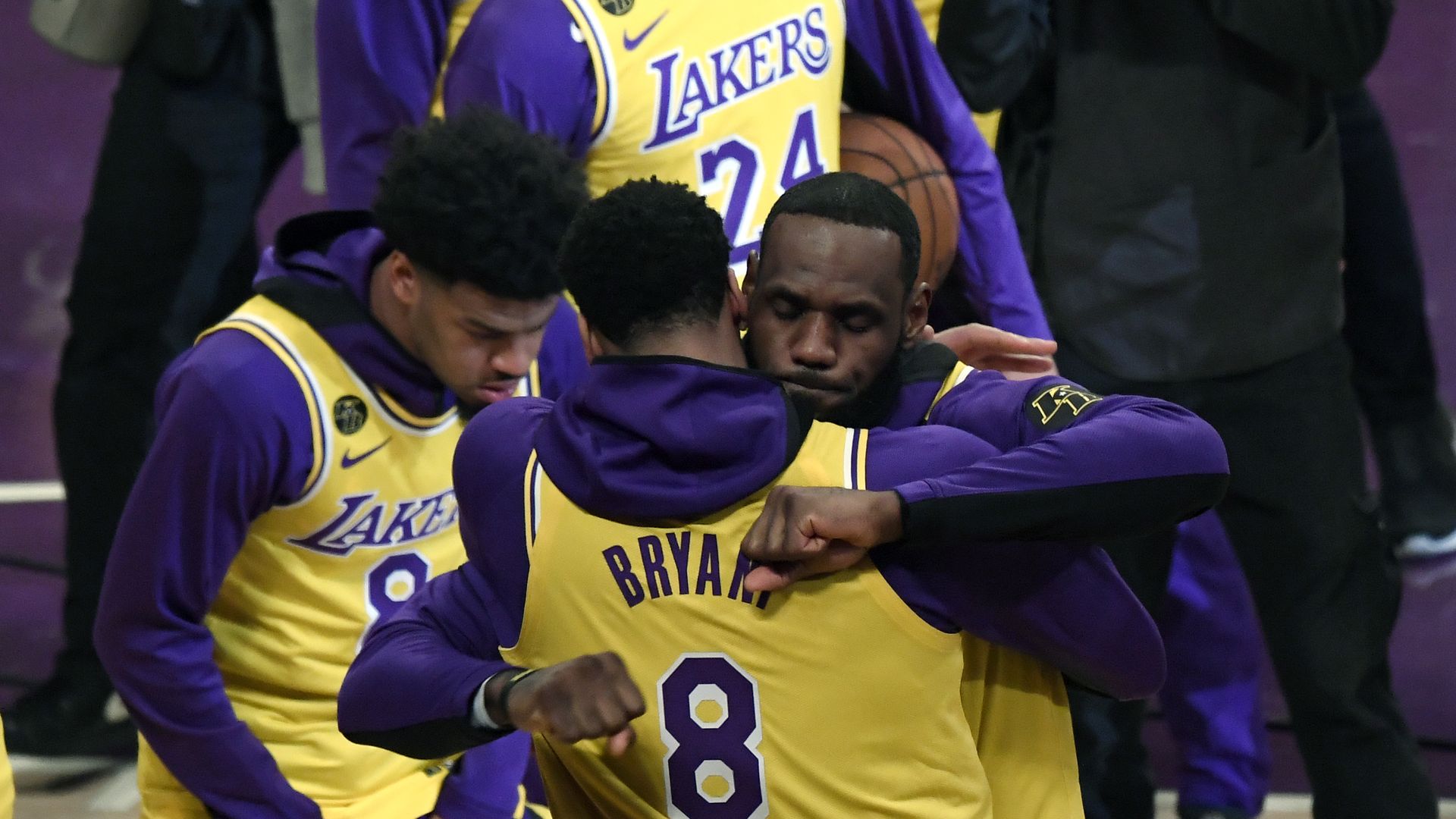 In this image, LeBron James hugs a teammate on the court