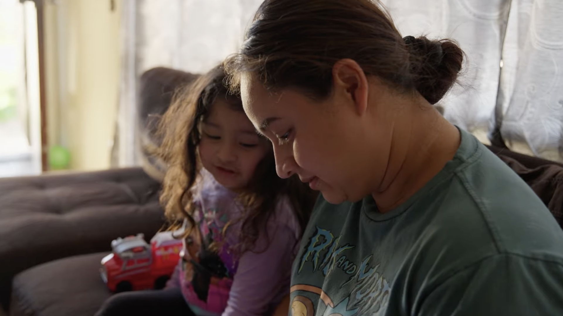 Paloma Sanchez, an undocumented single mom in Fresno, Calif., reads with her 7-year-old daughter in their apartment.