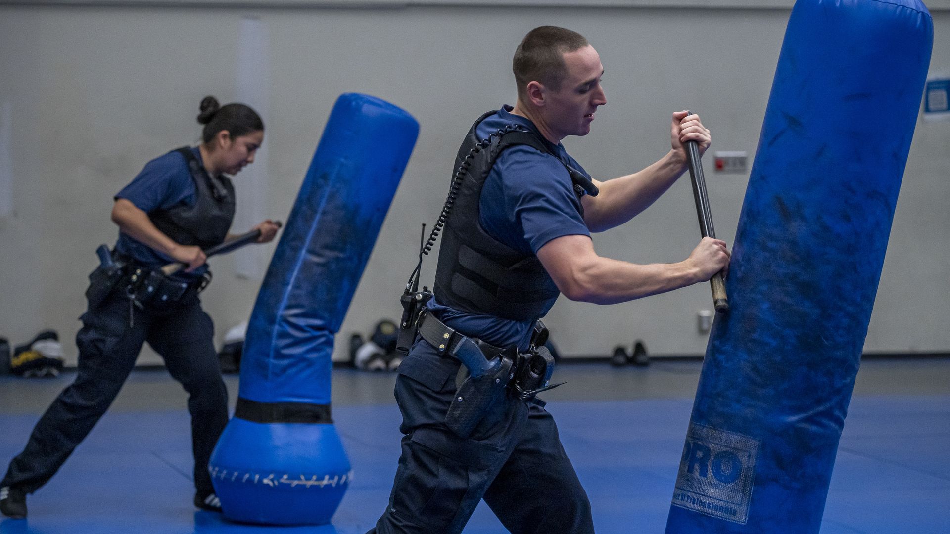 Photo of two police recruits training with punching bags