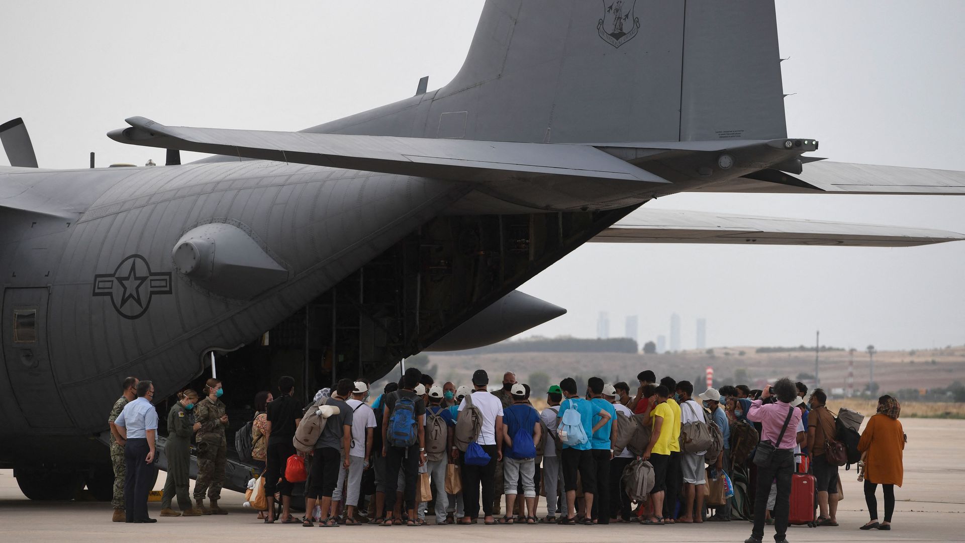 Refugees board a US aircraft heading to Germany, after being evacuated from Kabul.