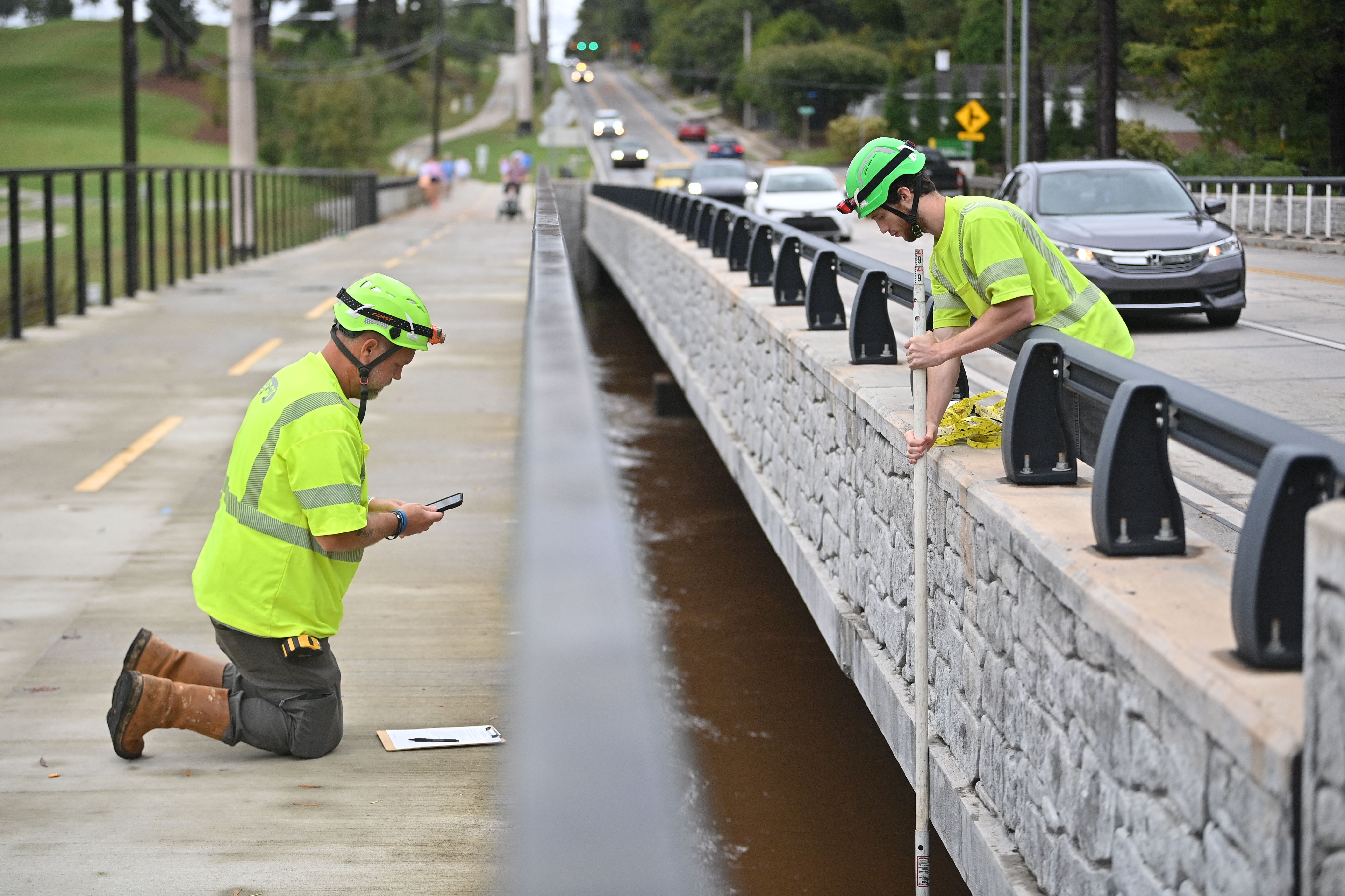 City crews measure the water level of Peachtree Creek along Northside Drive in Atlanta.
