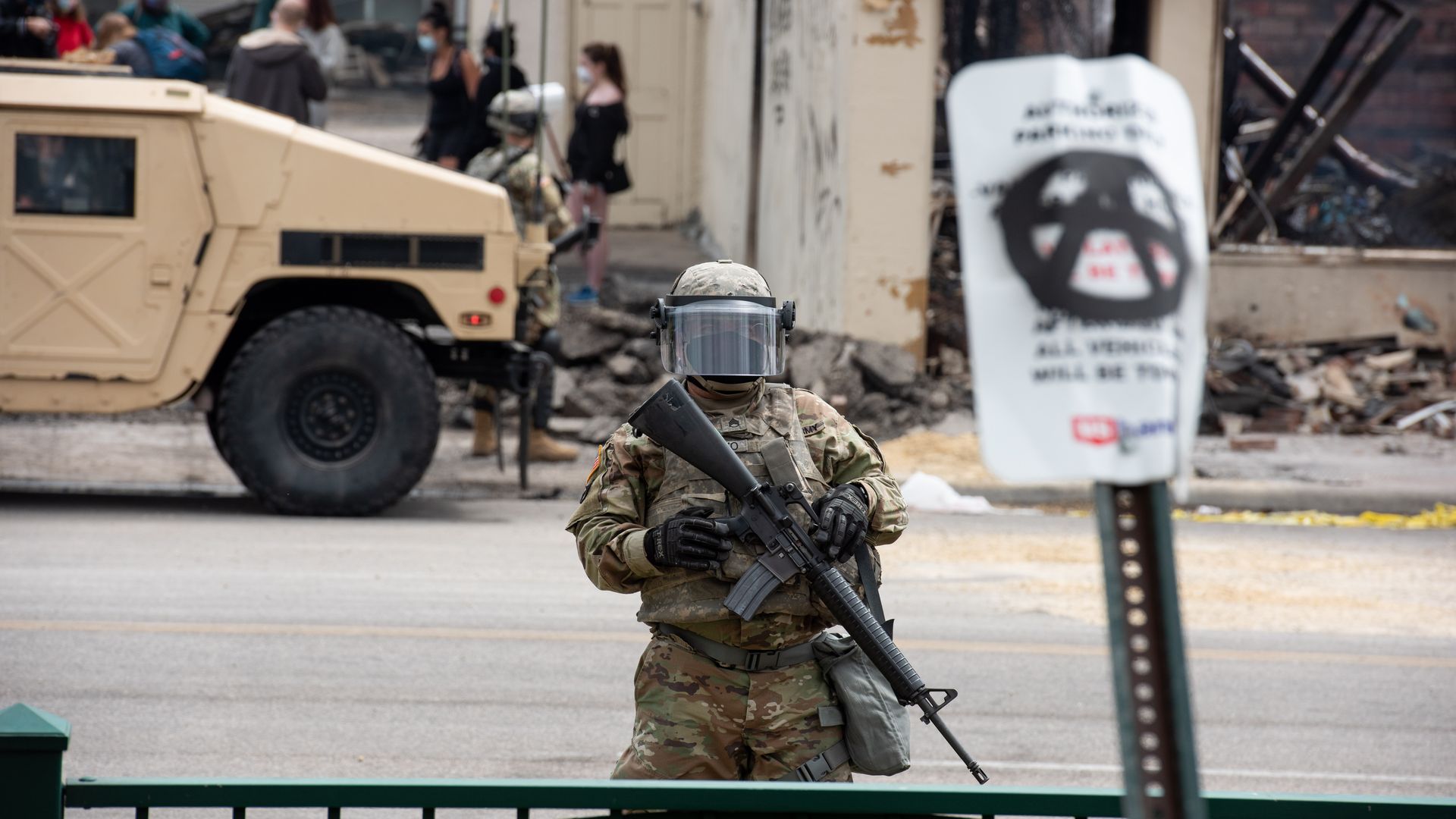 National Guard troops help block off a section of a street in Minneapolis