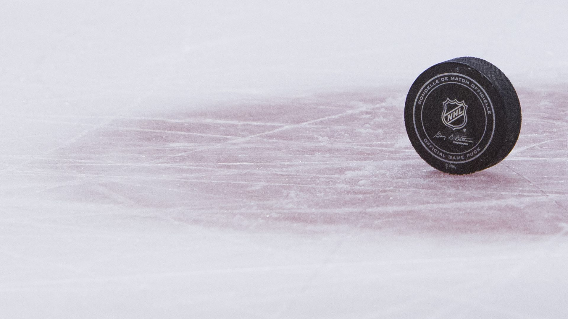 Hockey puck upright on ice