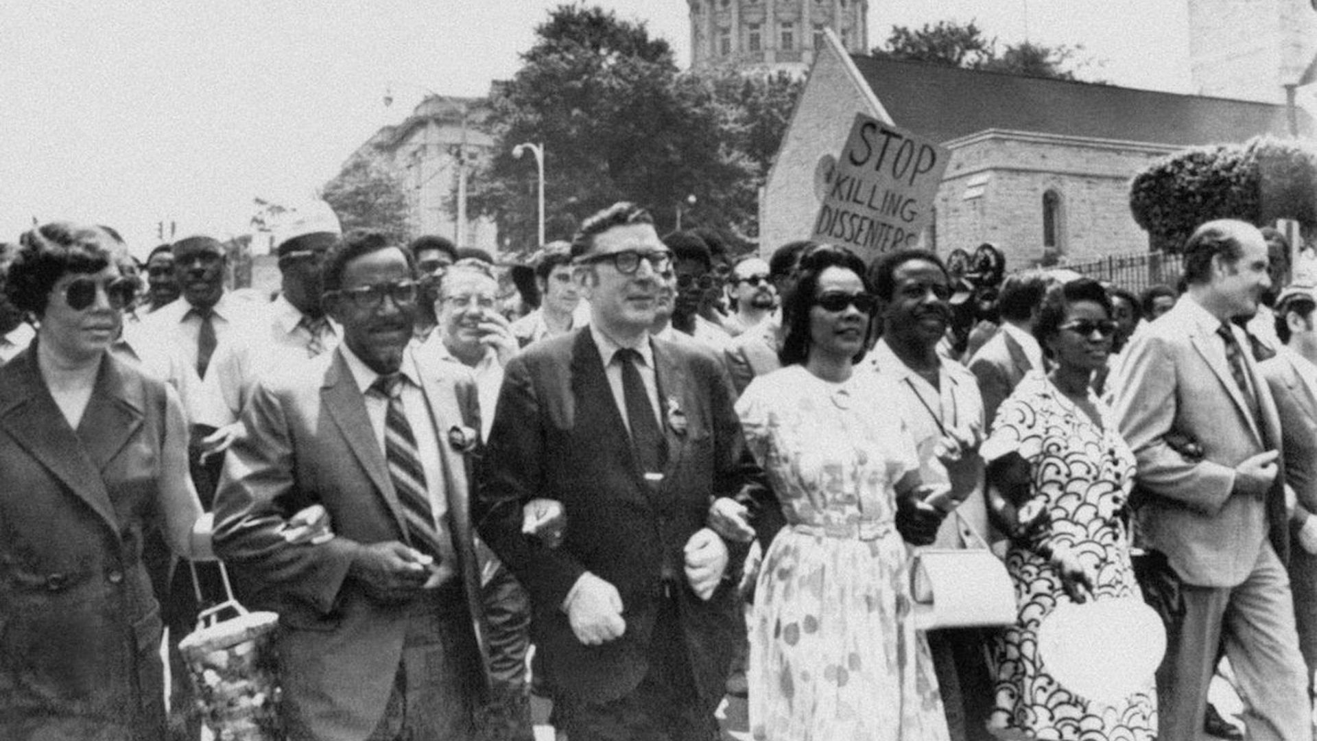 Rev. Joseph Lowery and Coretta Scott King lock arms with UAW president Leonard Woodcock as they lead several thousand marchers past the Georgia State Capitol in Atlanta