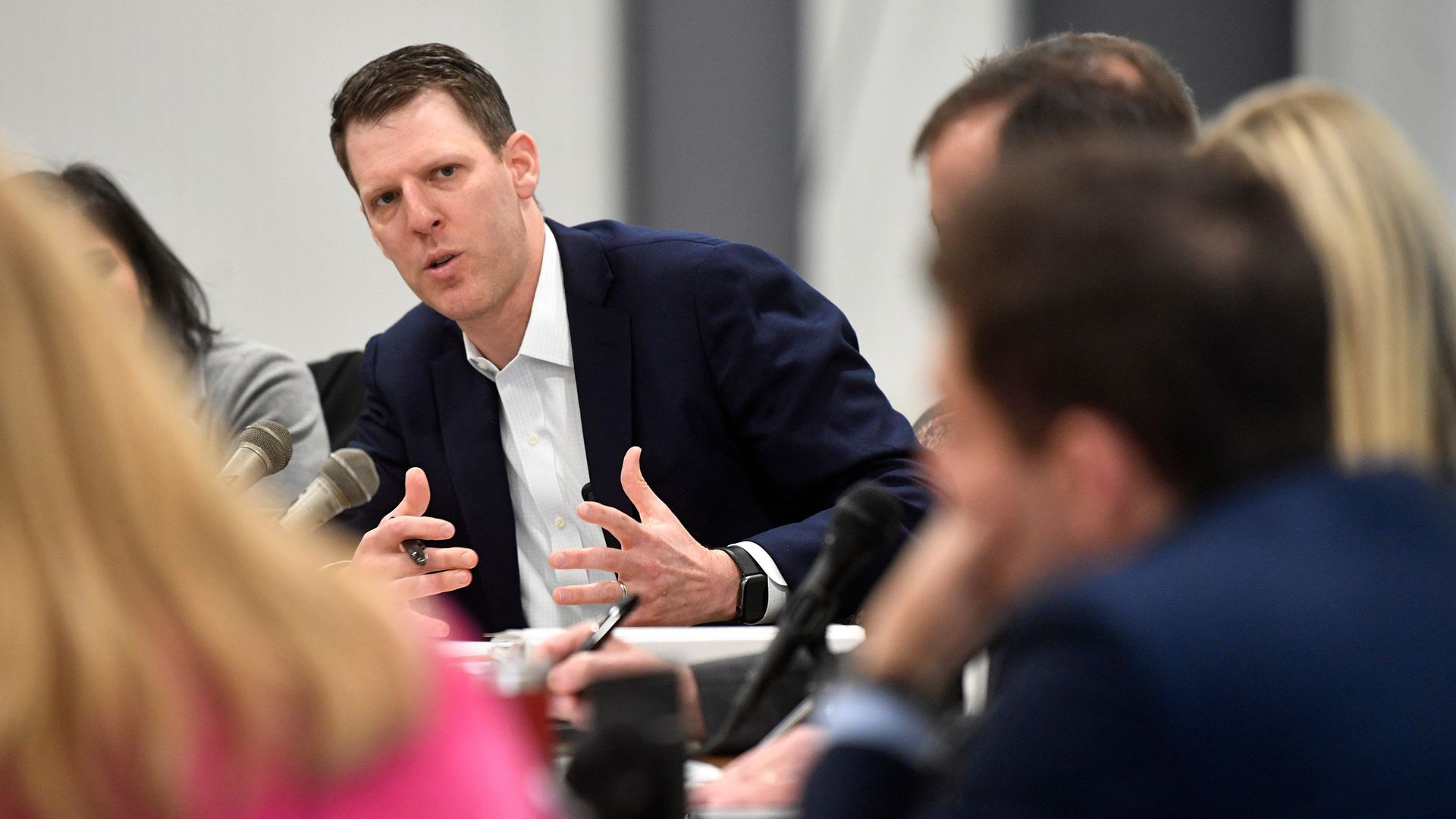 Caleb Hemmer sits at a roundtable 