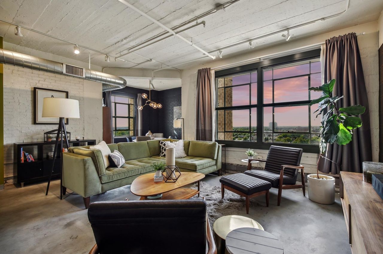 large living area with industrial design elements and accent walls