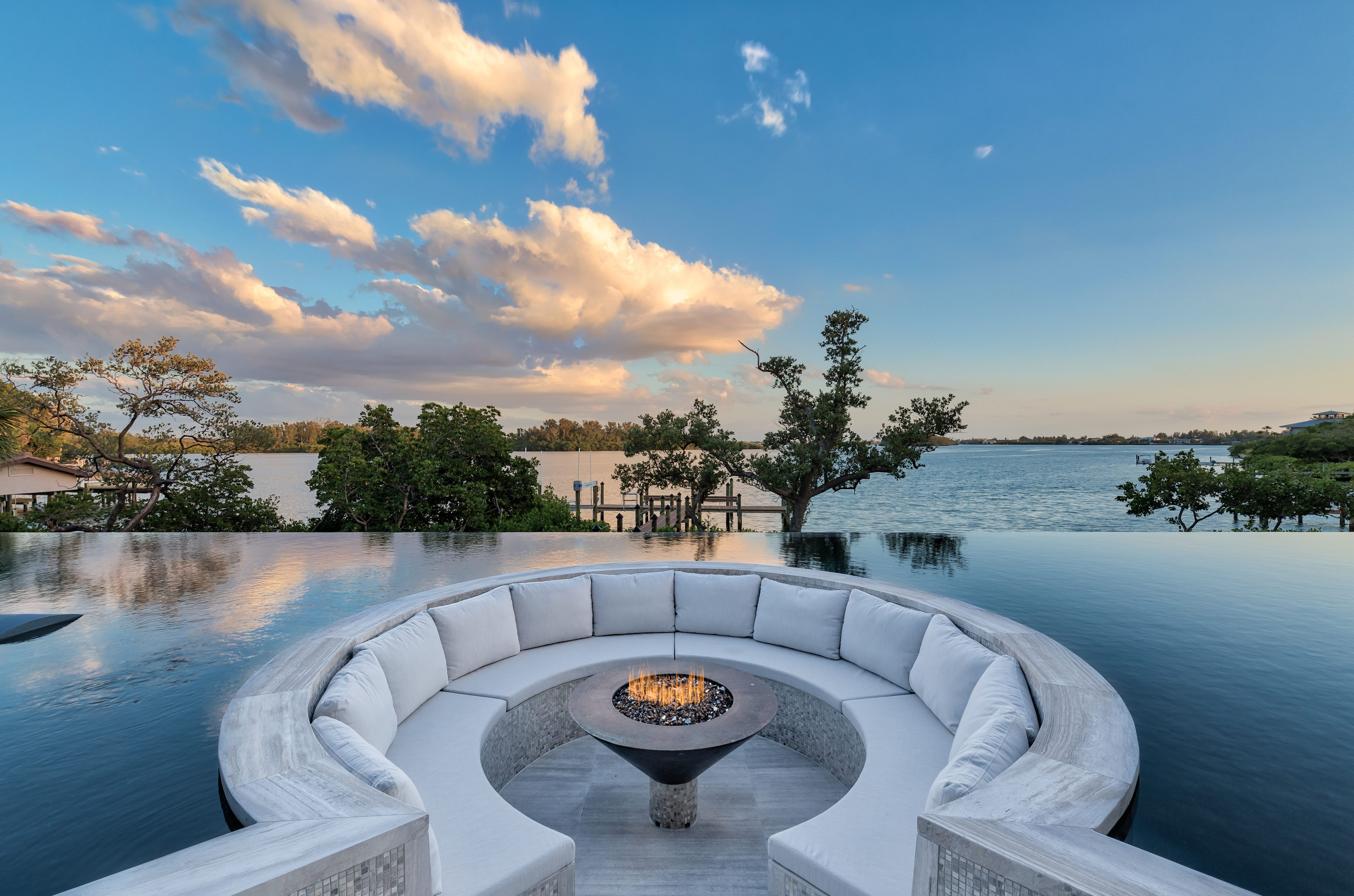seating area with  fire pit recessed into the infinity pool 