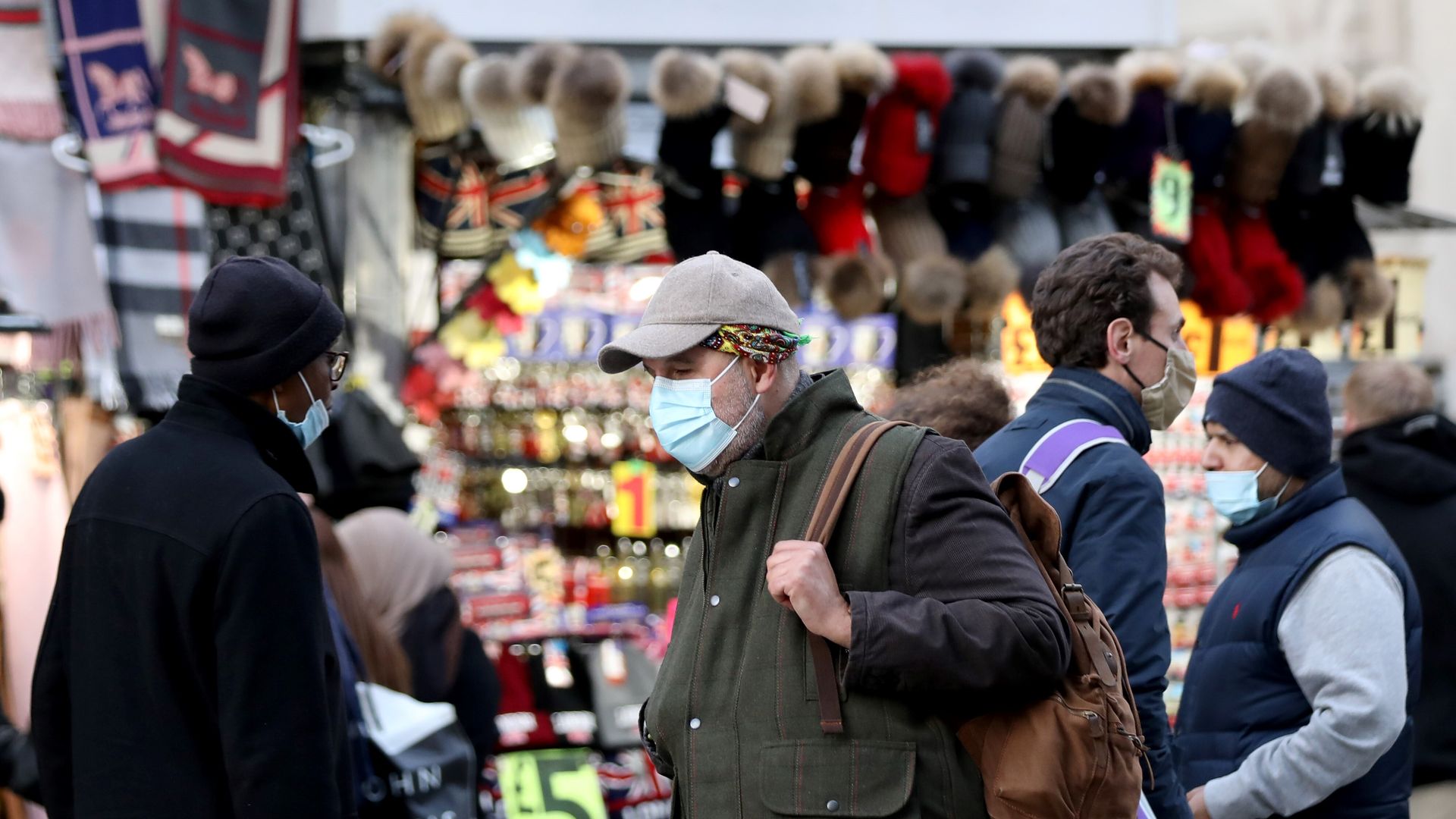 People wearing masks walk in London, Britain, Nov. 25, 2021