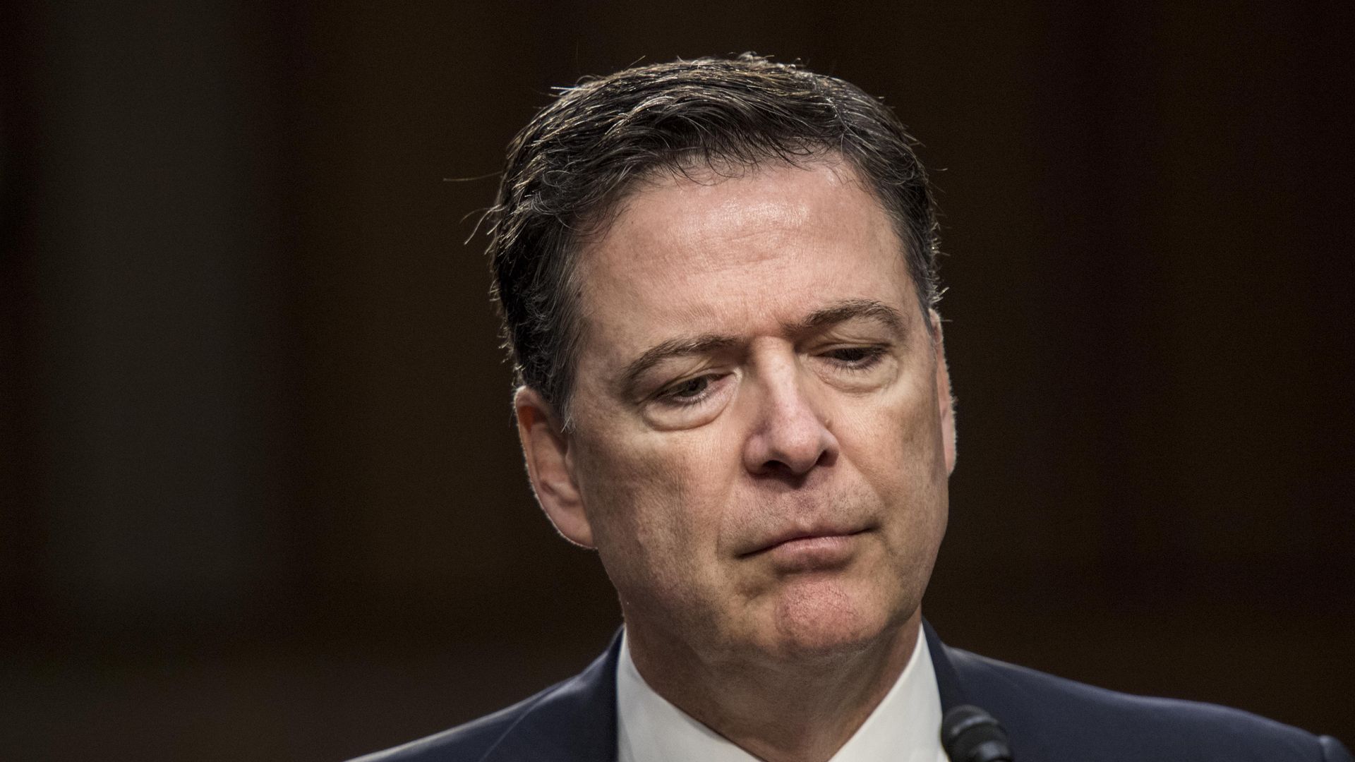 james comey looking down in suit